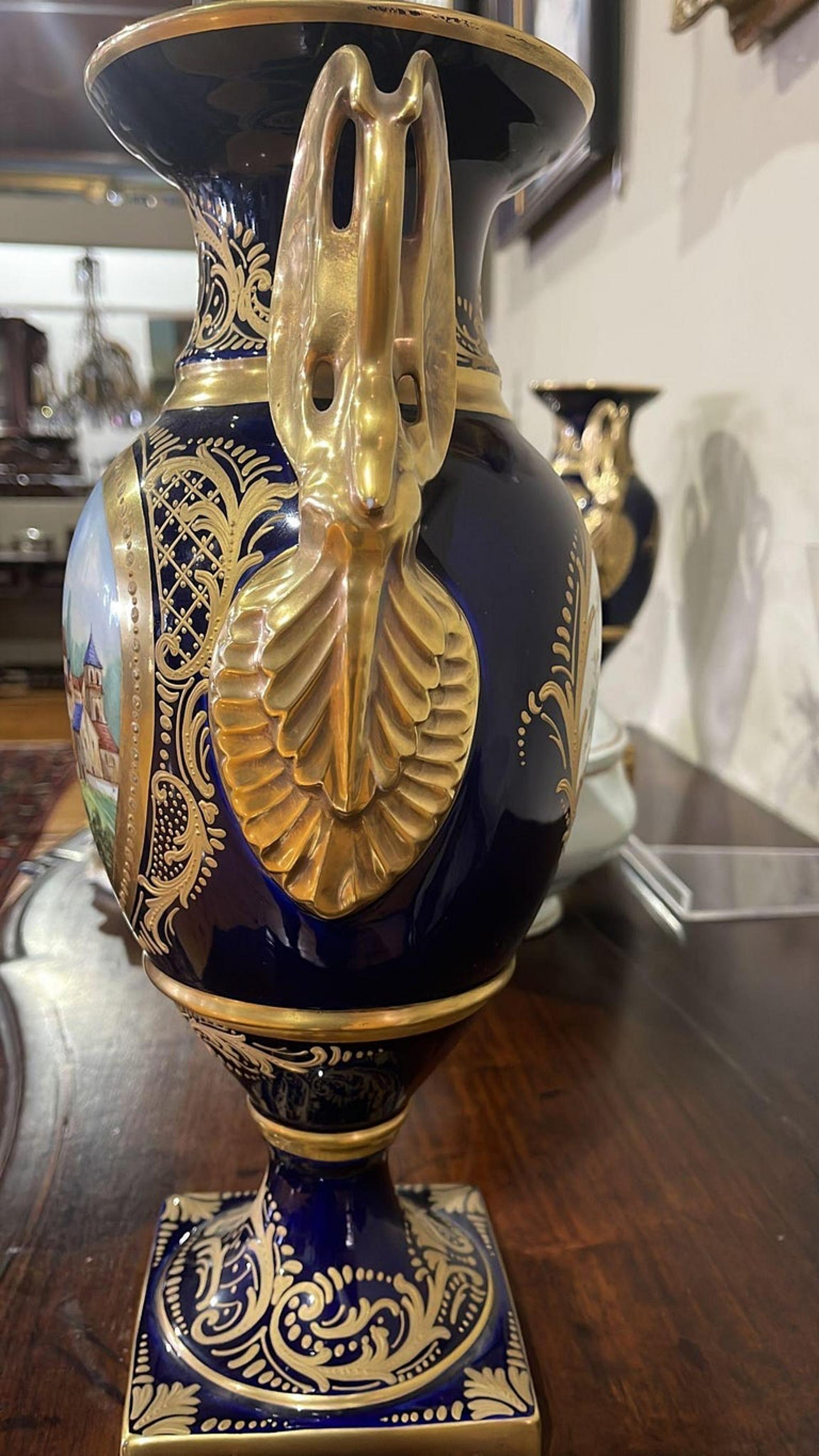 Pair of vases

French, early 20th century in Sèvres porcelain, cobalt blue and gilt decoration with polychrome reserves 