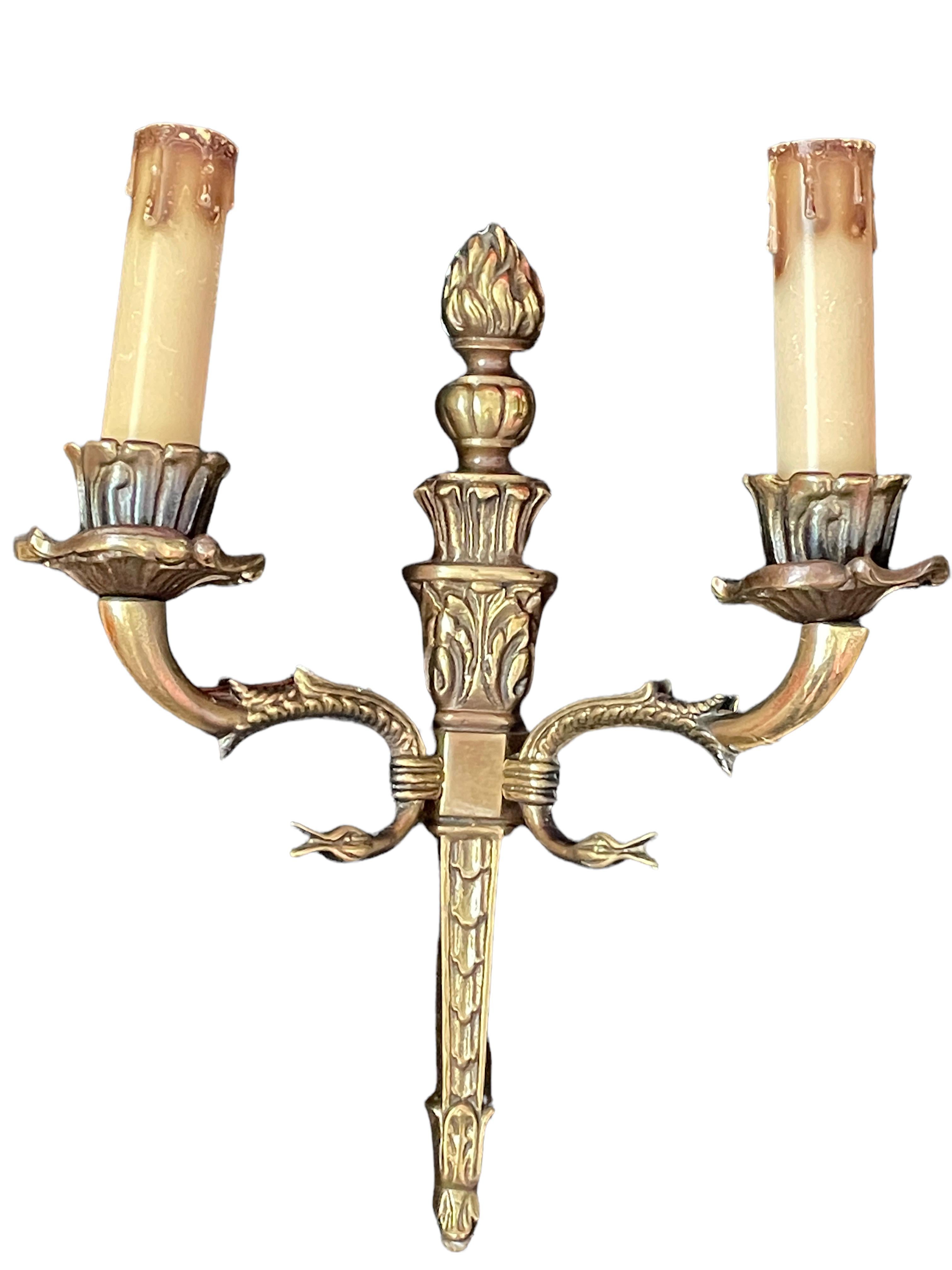 Pair of nice Sconces. Each fixture requires two European E14 candelabras bulbs, each bulb up to 40 watts. The wall lights have a beautiful patina and gives each room an eclectic statement. Made of bronze metal. Nice addition to any room.