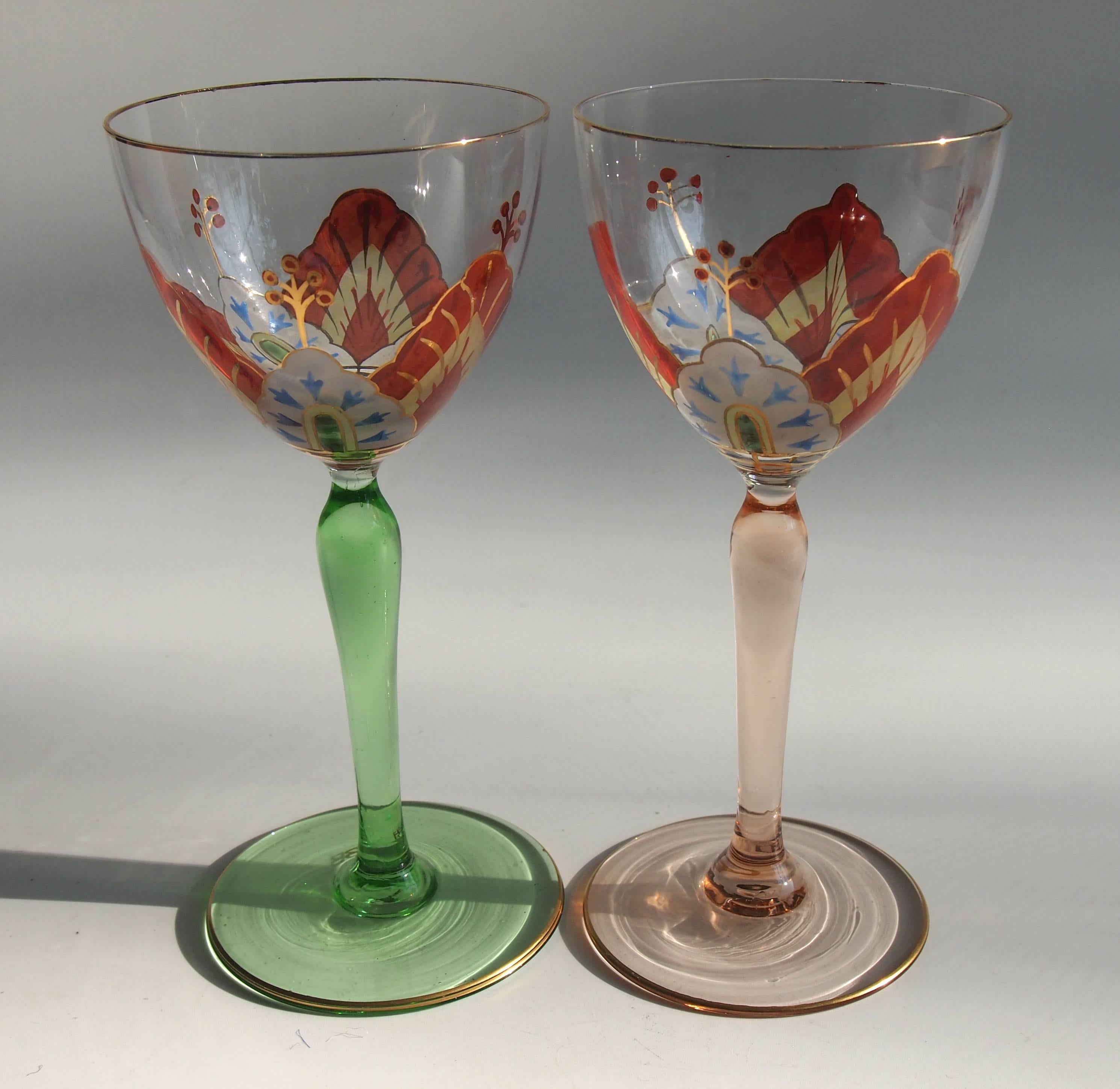 Superb pair of gilded and enameled Ferdinand Von Poschinger 'Flower' glasses. One with a green stem and one with a pink stem. They are enamelled with an open flower around the bowl so only when you drink from them do you get the full effect of the