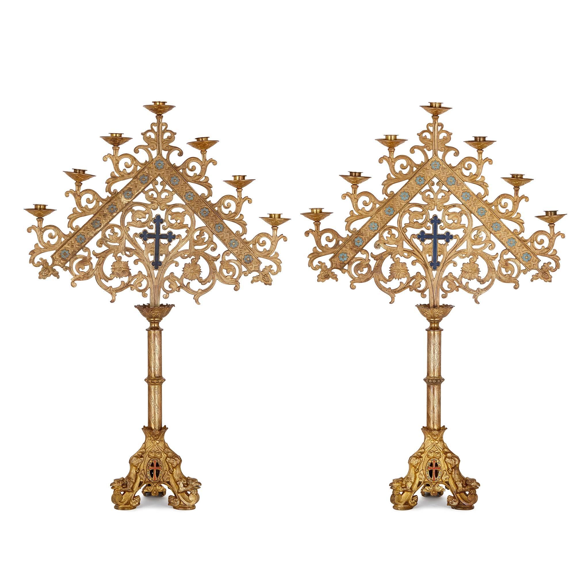 Finely worked in gilt bronze, and delicately enameled, this impressive pair of altar candlesticks is the work of an exceptionally skilled craftsman. Built in the Baroque style, each candelabrum has seven lights arranged in a triangular shape, each