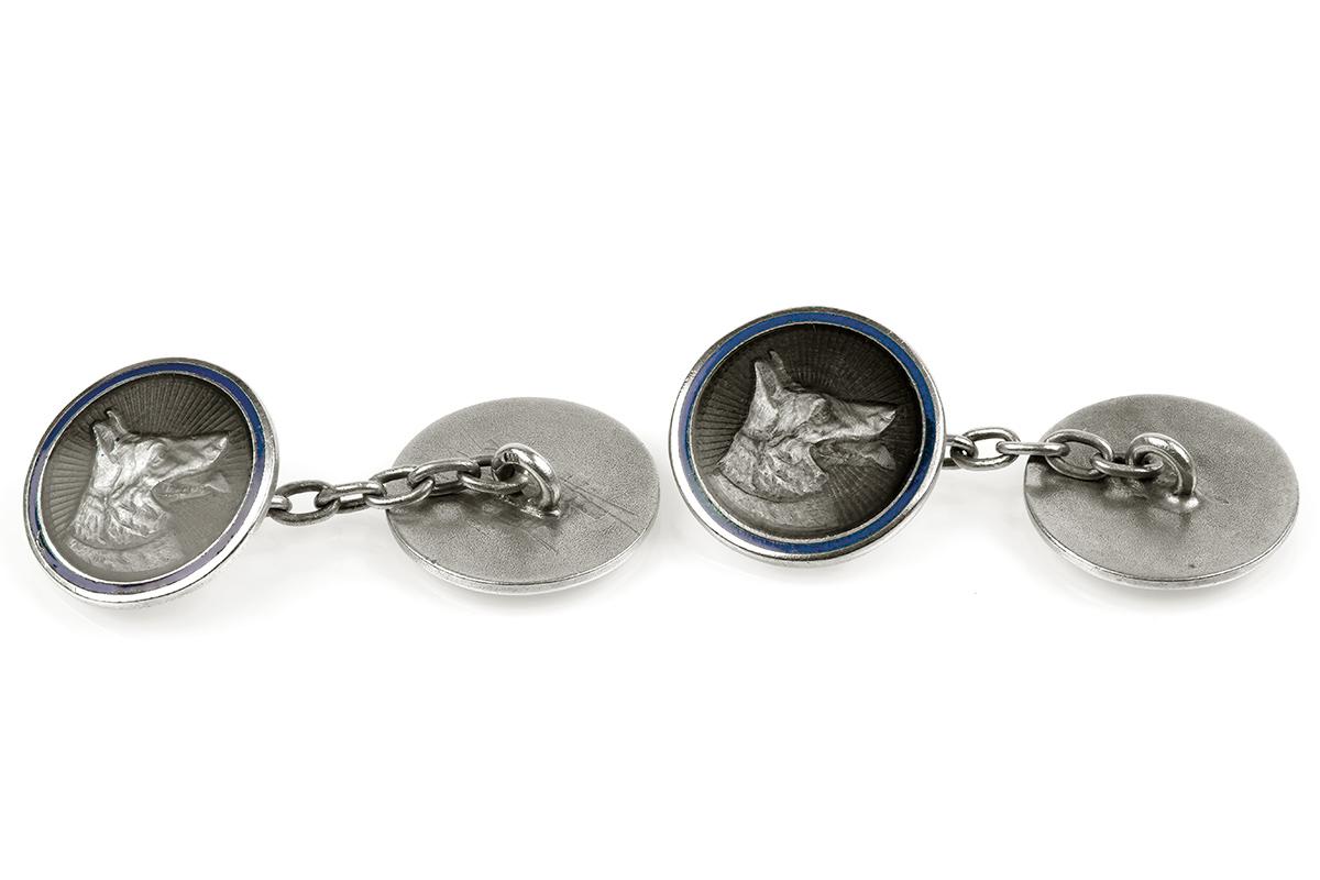 A very unusual pair of antique double sided cufflinks depicting German Shepherd dogs heads. Made in silver, decorated on enamel with a lapis lazuli blue enamel border and chain connections. Stamped 800 (800 parts silver, 200 parts alloy).
Measures