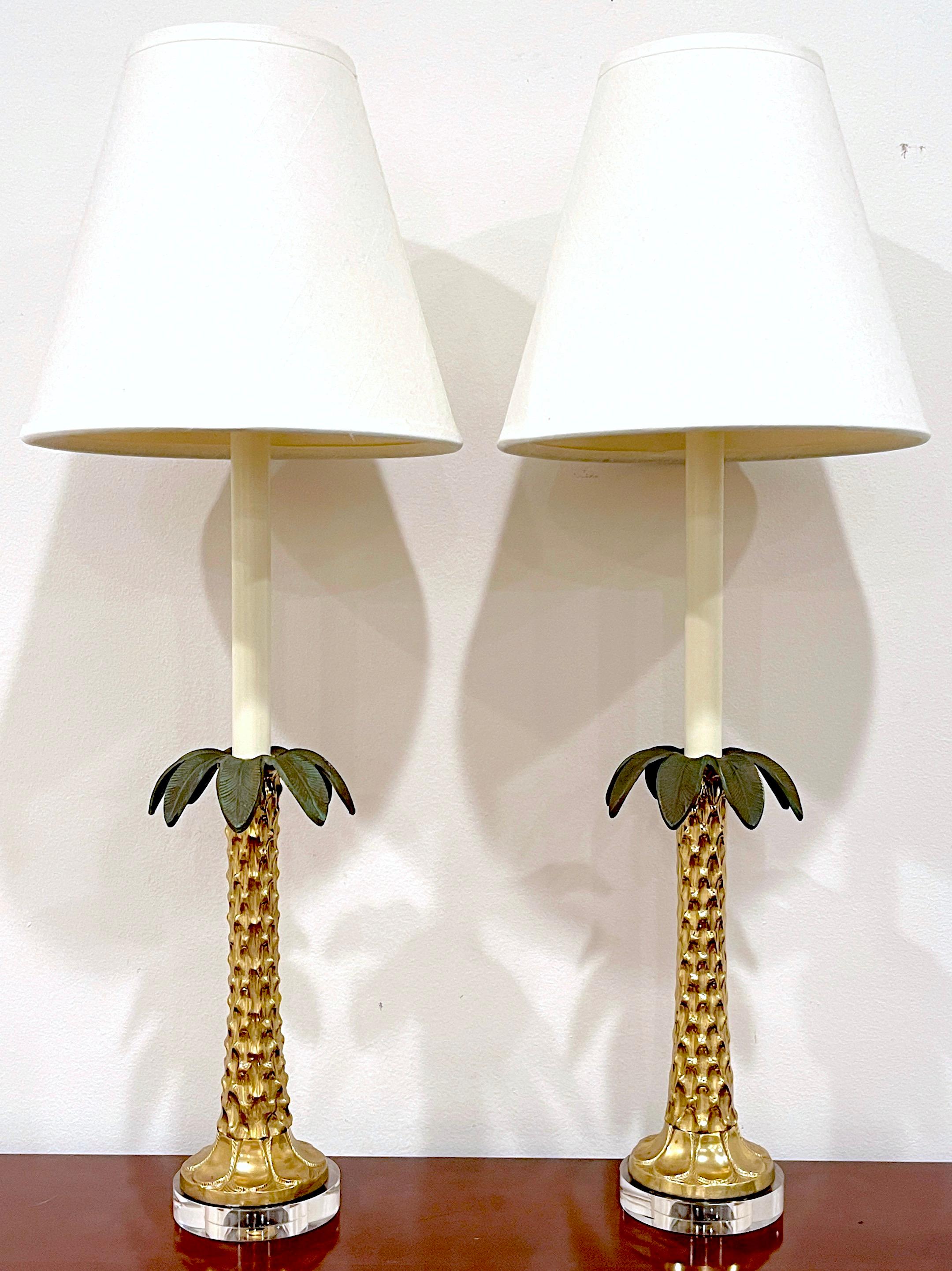 Pair of Enameled Brass & Lucite Palm Tree Lamps
USA, 1980s
A striking pair of Enameled Brass & Lucite Palm Tree Lamps from the 1980s encapsulates the essence of tropical whimsy. Each lamp features eight enameled palm fronds, The realistic cast and