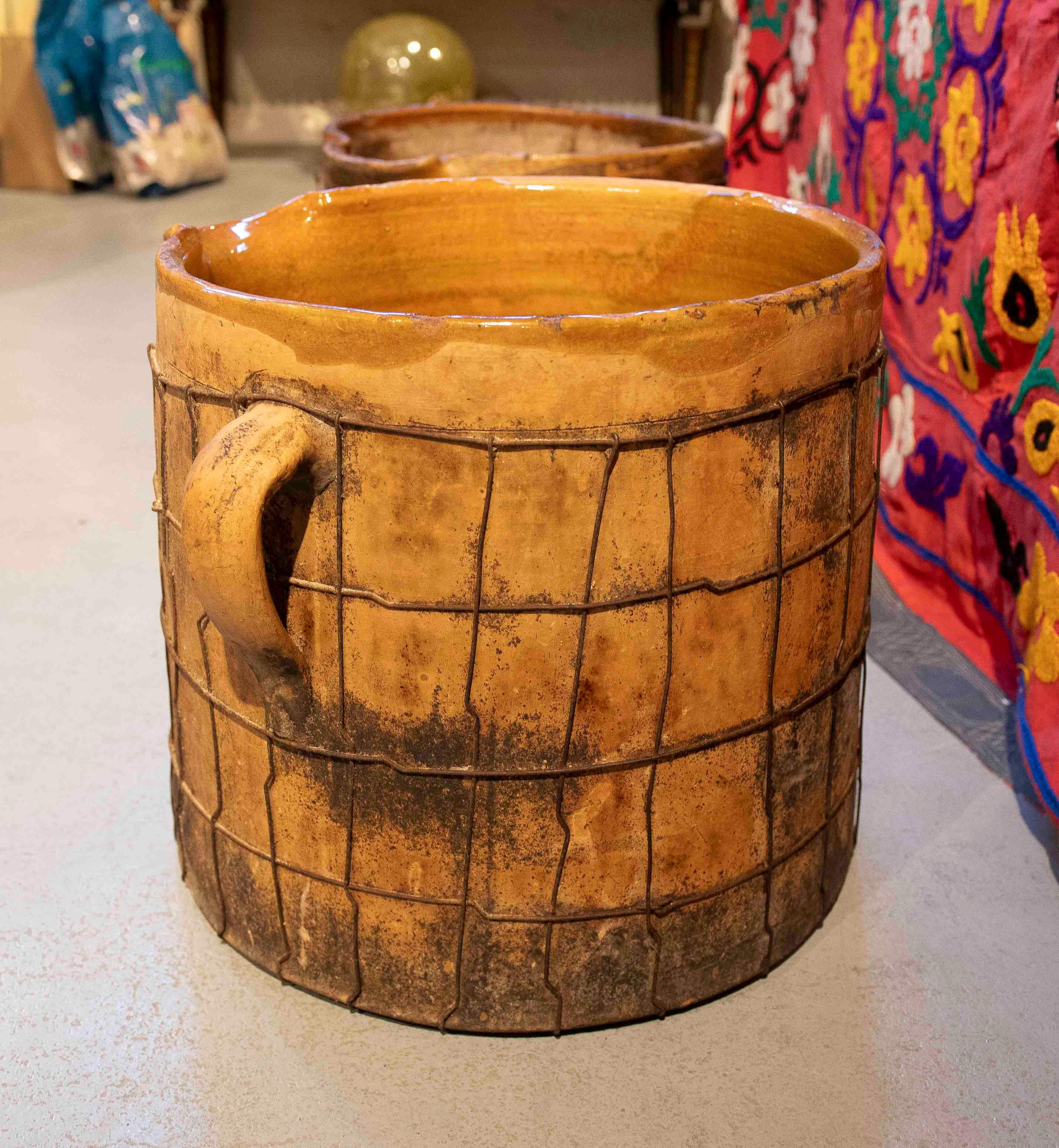 Pair of Enameled Ceramic Milk Churns with Handles & Iron Netting Covering Them For Sale 4