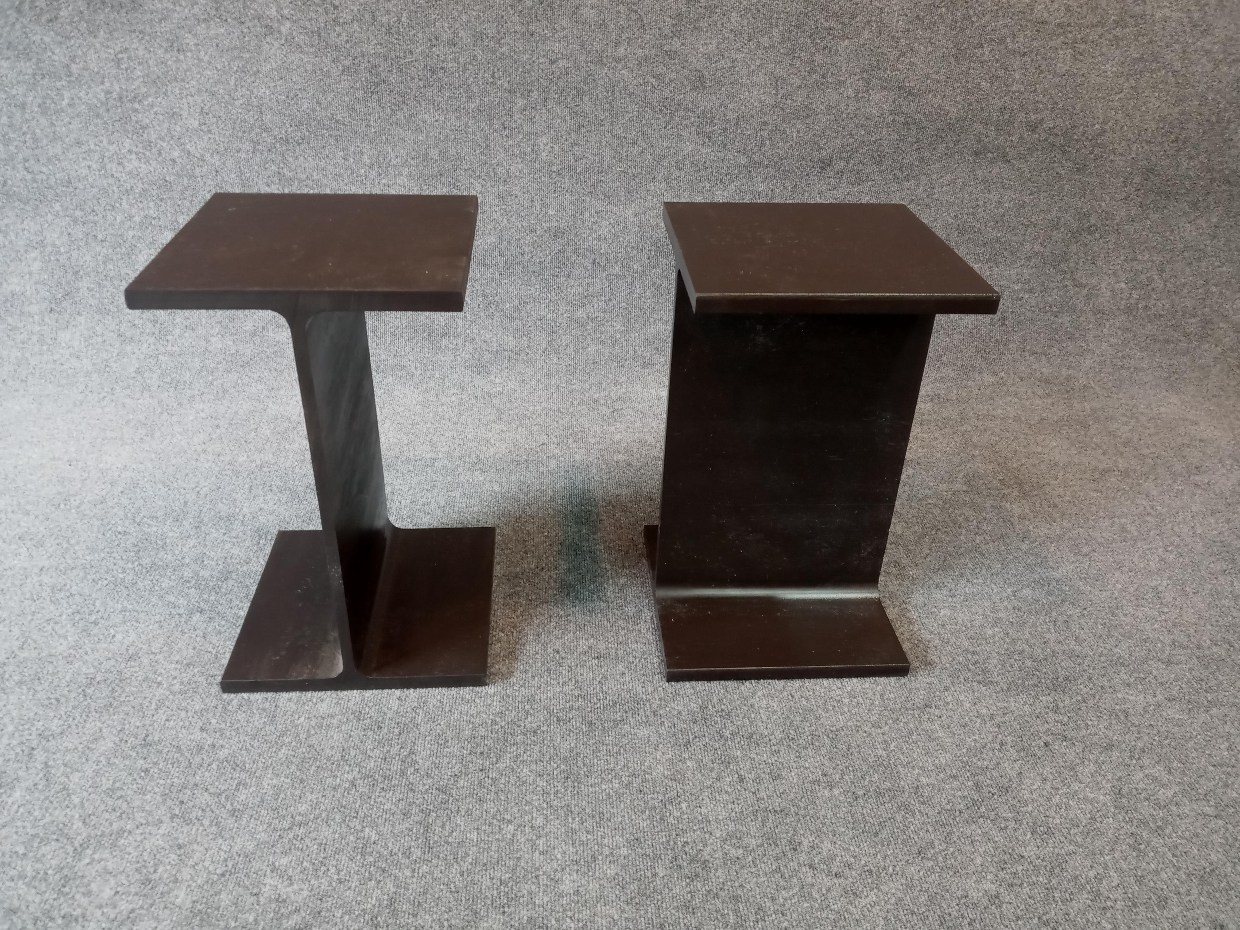 In creating a prototype, Ward Bennett actually cut off a section of a steel I-beam to achieve the raw aesthetic he was after. Here, a pair of solid enameled steel side tables. Each is very well made, with crisp surfaces and edges. A pair of superb