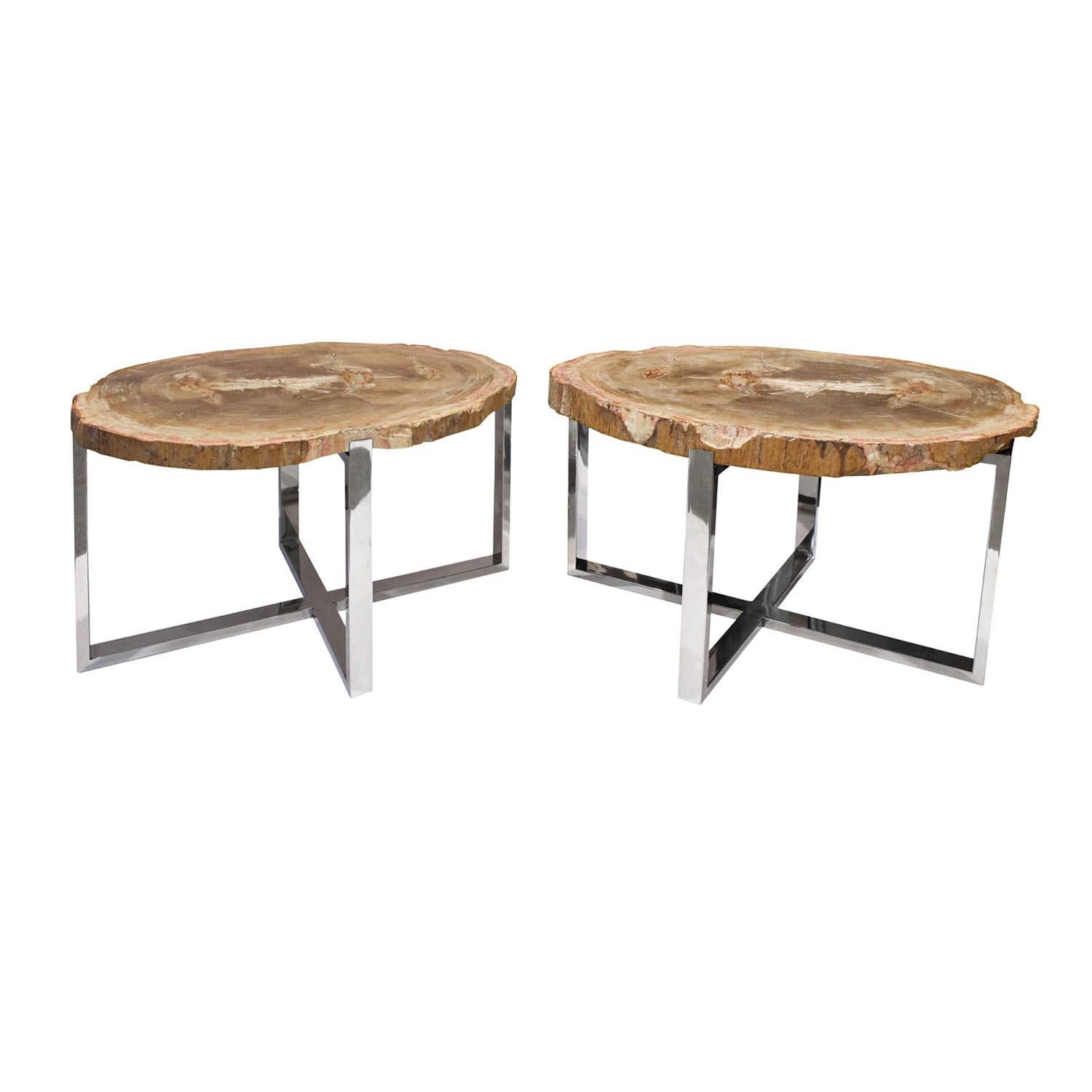 Pair of beautifully crafted end/coffee tables with bases in polished chrome with inset petrified wood tops with natural edges, custom design, American 1990's. The incorporation of petrified wood makes them extraordinary. These can be used as end