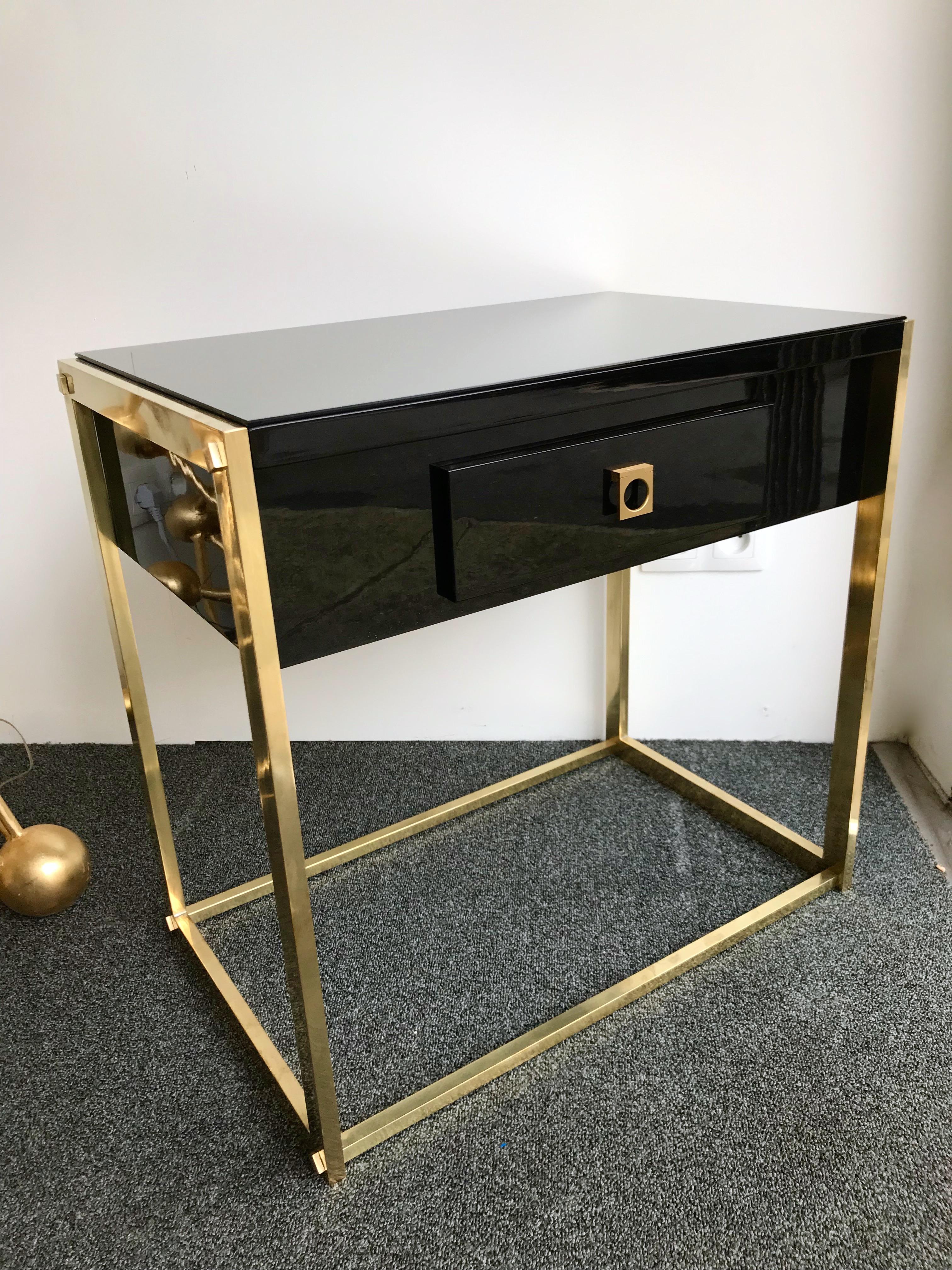 Rare model of lacquered and brass side end tables or nightstands by Guy Lefèvre for Maison Jansen Paris. Black lacquer, interesting brass feet with decorative screw elements, mirror glass top, wood interiors drawers. Famous manufacture like Baguès,