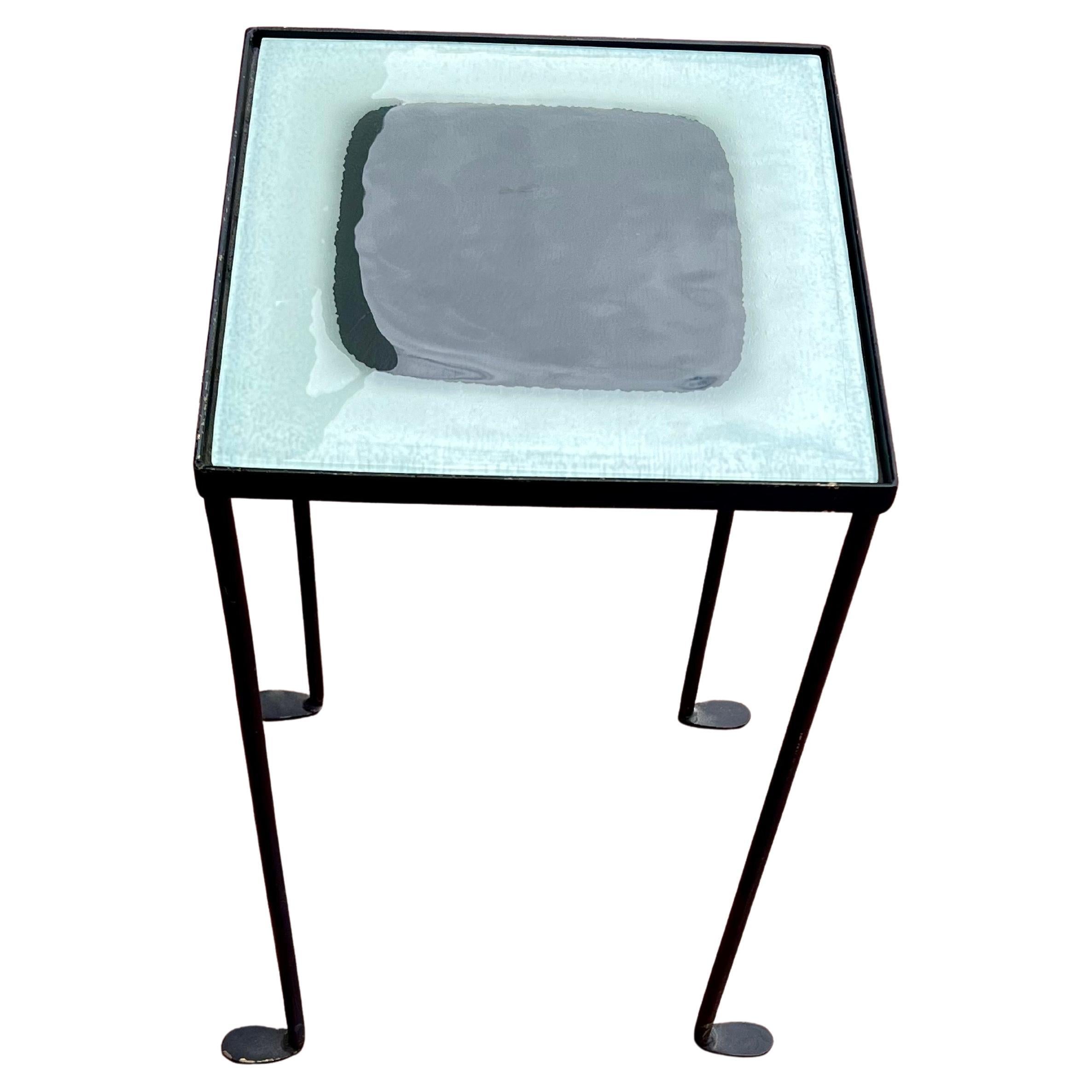 A unique pair of rare side tables circa 1990's , solid iron frames with beautiful glass tops great design by California artist Anna Cabo, versatile and rare inspired by Italian designer Gaetano Pesce. in black enameled frames finish.
