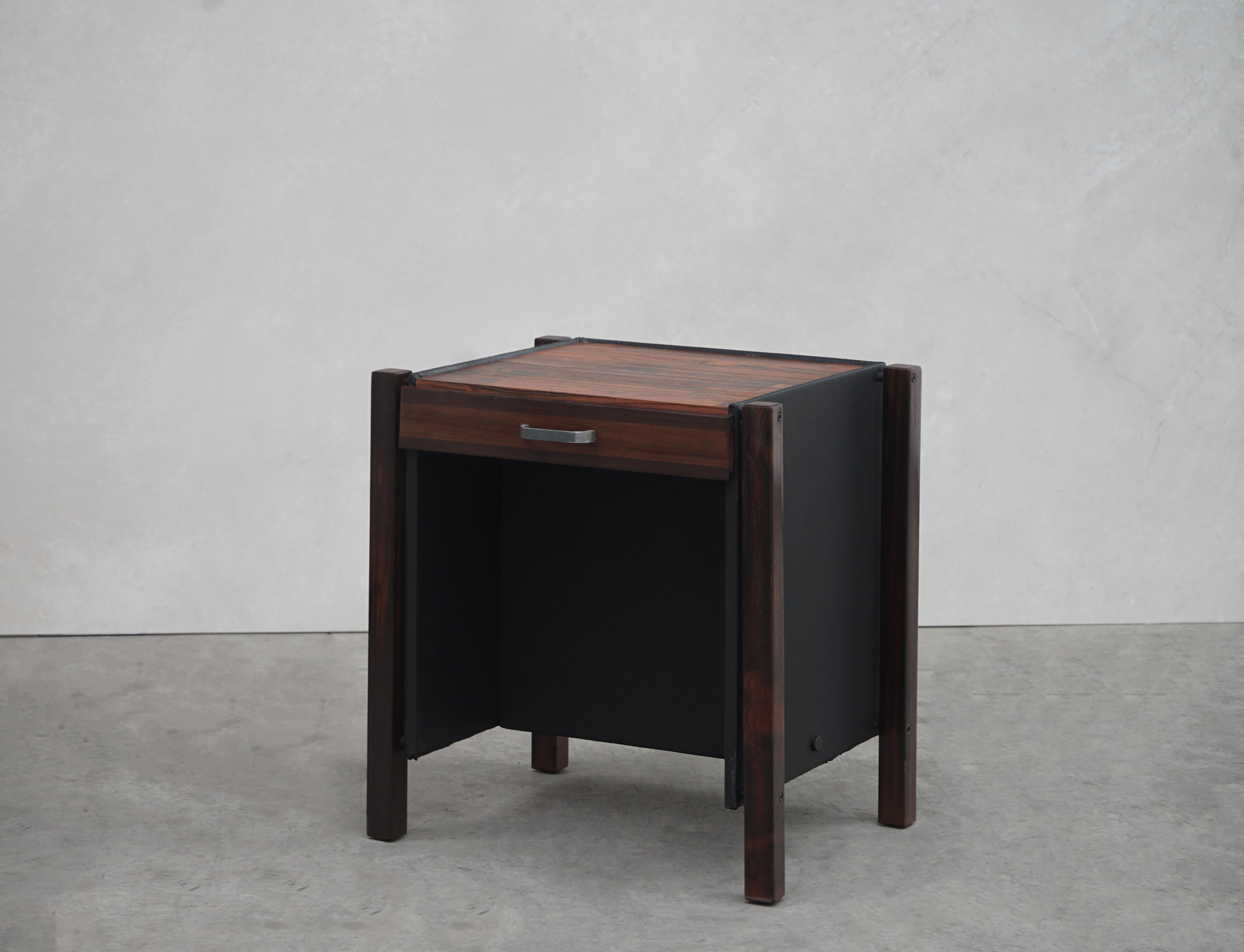 Designed by Jorge Zalszupin, a pair of end tables, Rosewood, and leather. Brazil, circa the 1960s. 

Pair of end tables made in Brazilian rosewood patchwork (Jacaranda), black leather and chrome.
 
The end tables feature a single drawer with
