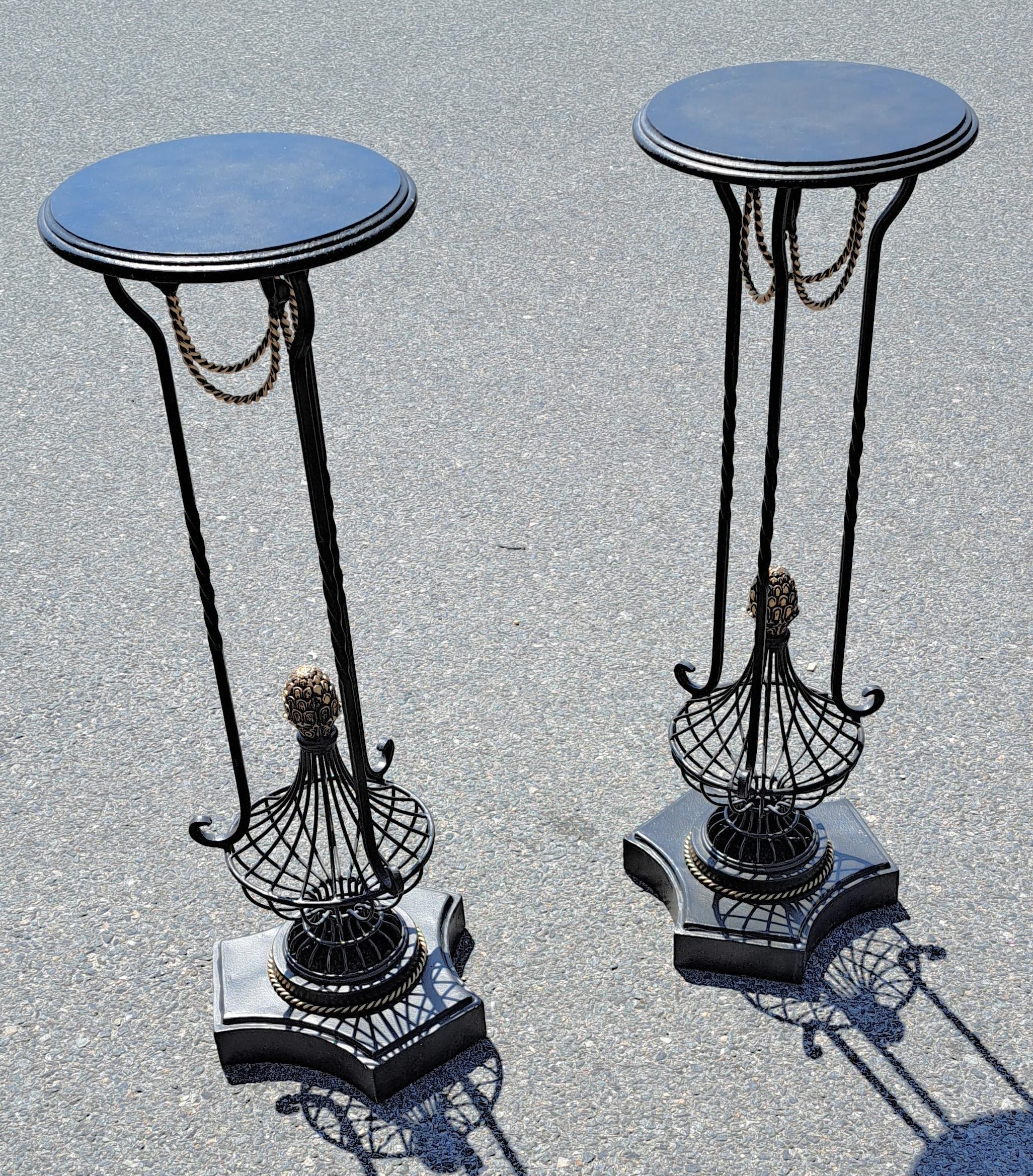 Elegant 19th century style wrought and gilt iron end tables / plant stands with intricate detail emphasizing a combination of geometric forms and stylized scrollwork.