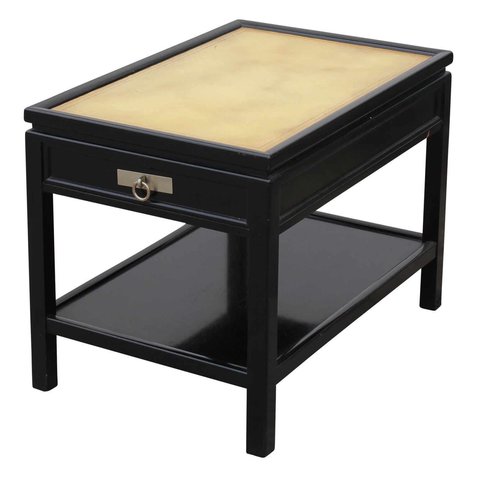 Incredible pair of black lacquer end tables. They have leather tops with a gold and black boarder. They have a small drawer on the front, and these end tables are attributed to Michael Taylor for Baker Furniture.
Note the handle on the front of the