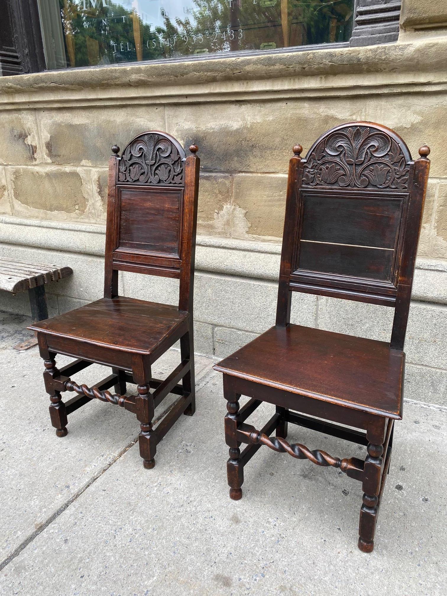 Pair of English 17th century period oak hall chairs.