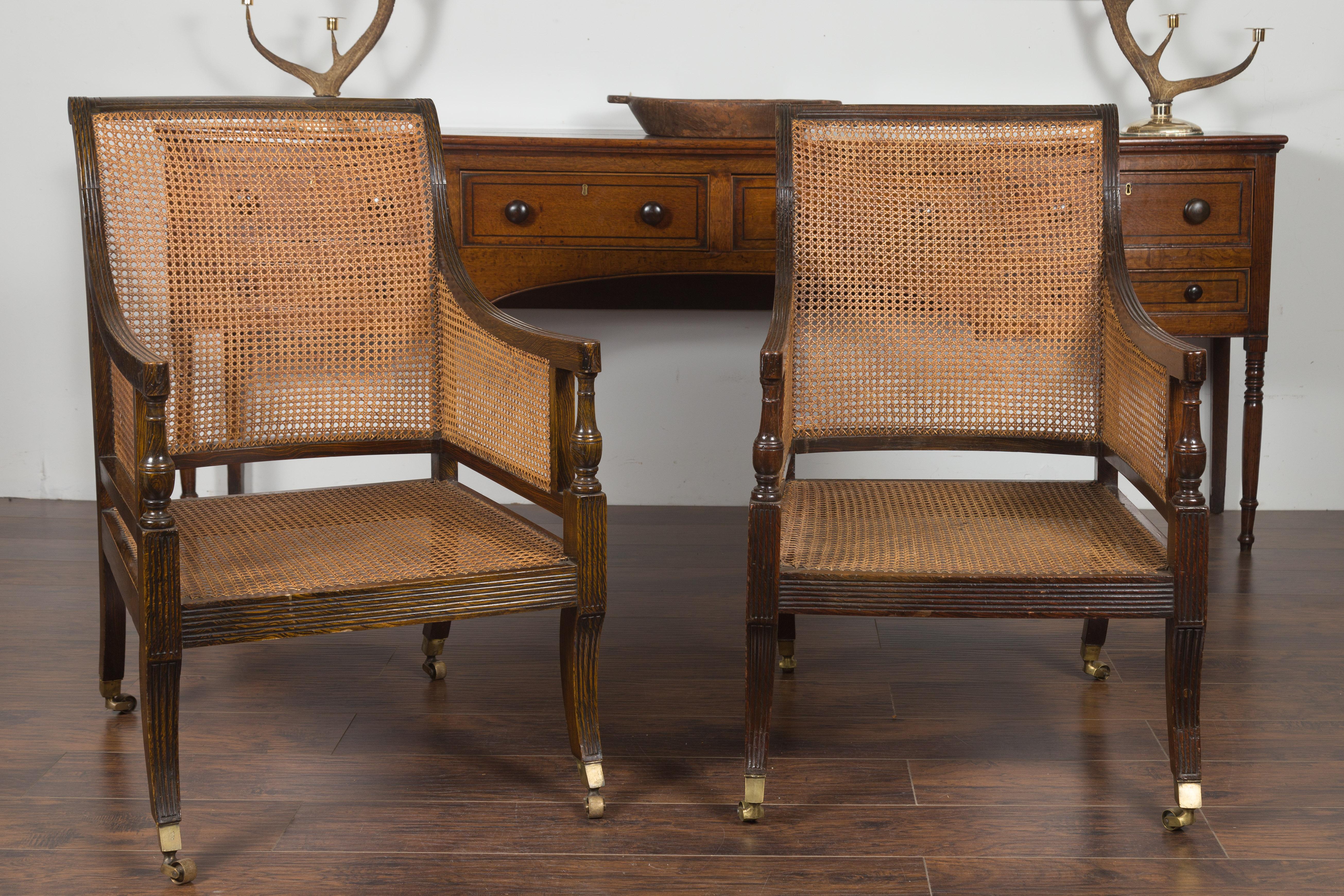 Pair of English 1870s Cane and Oak Library Chairs with Cushions and Casters 2
