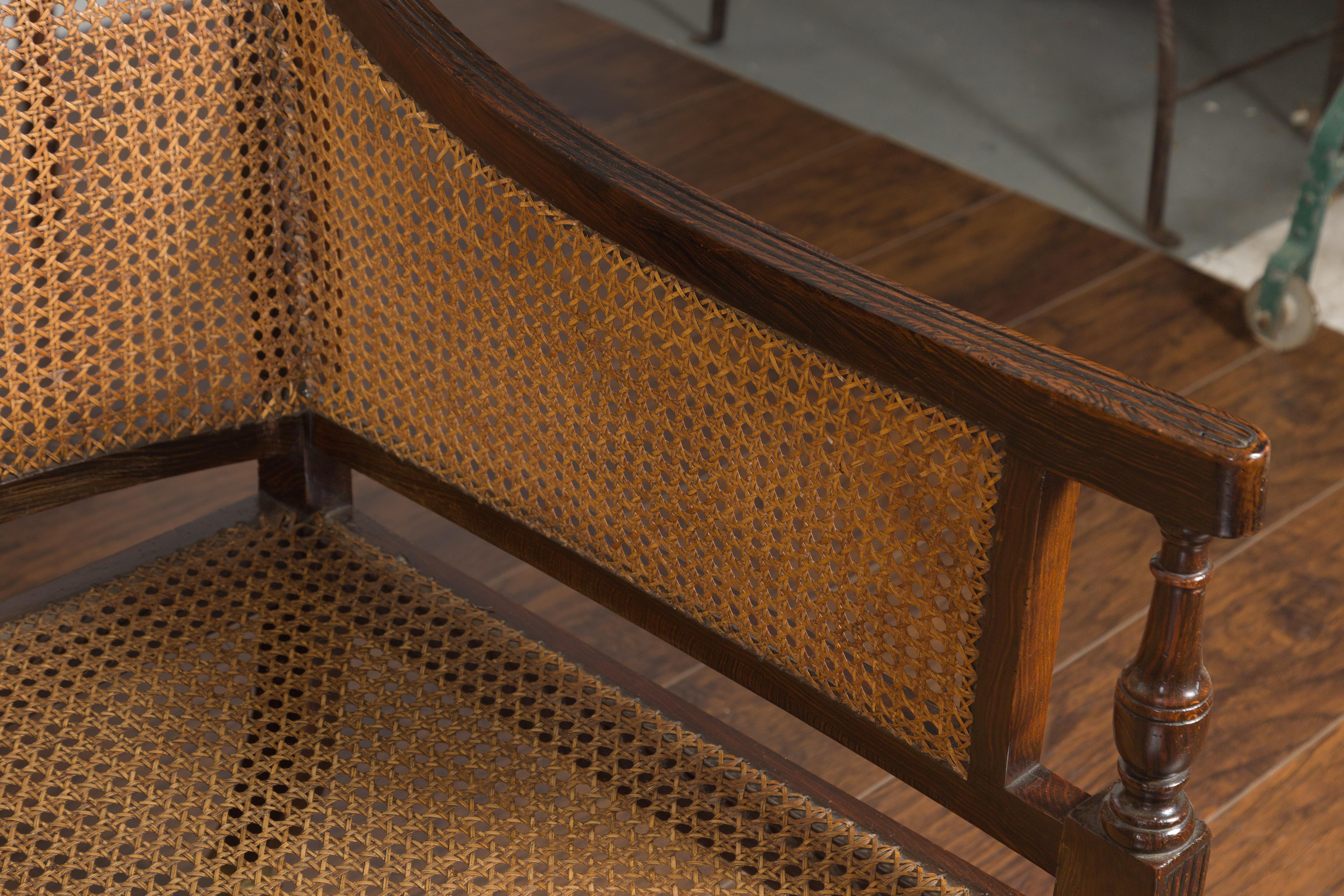 Pair of English 1870s Cane and Oak Library Chairs with Cushions and Casters 5