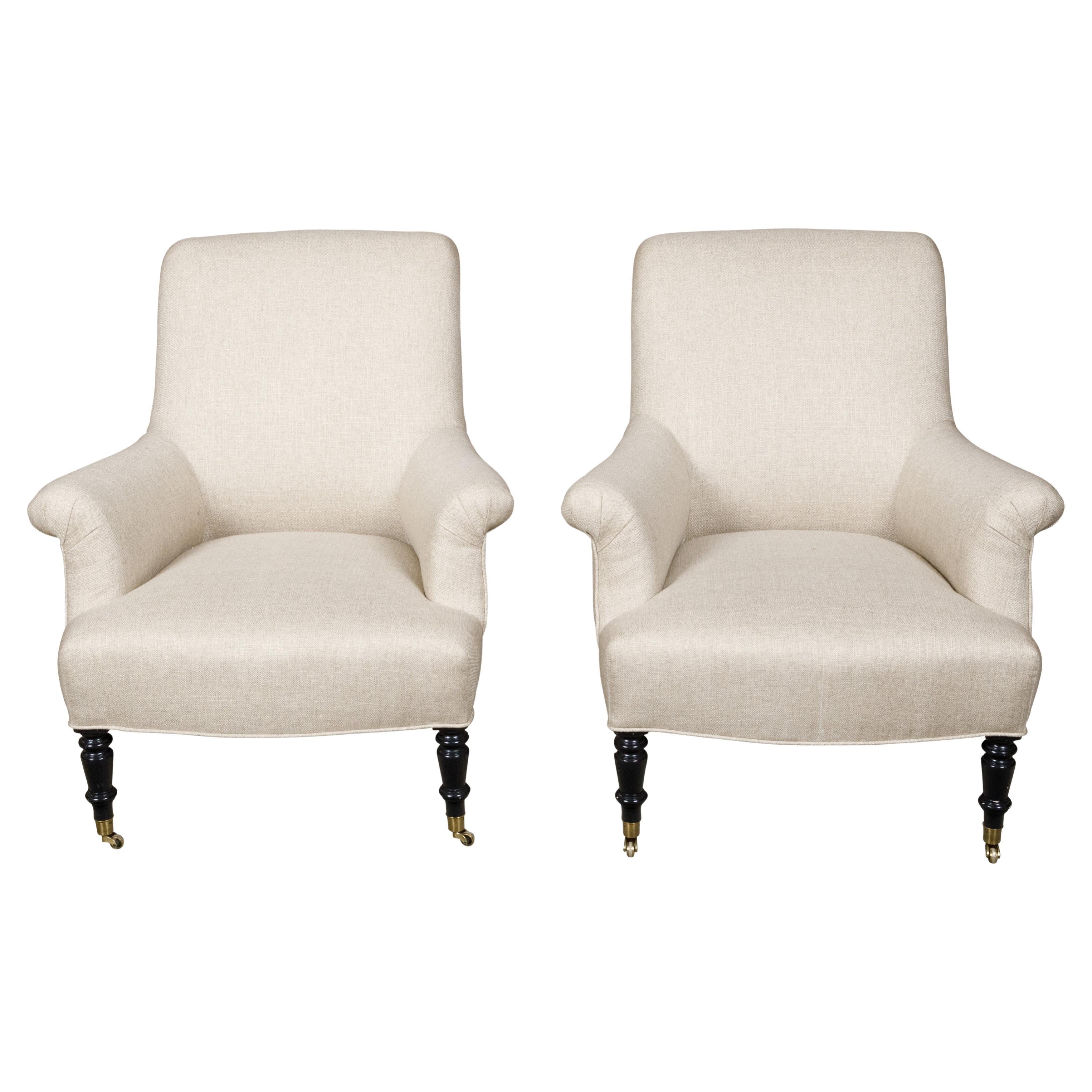 Pair of English 1880s Upholstered Armchairs with Ebonized Turned Legs on Casters