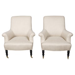 Pair of English 1880s Upholstered Armchairs with Ebonized Turned Legs on Casters