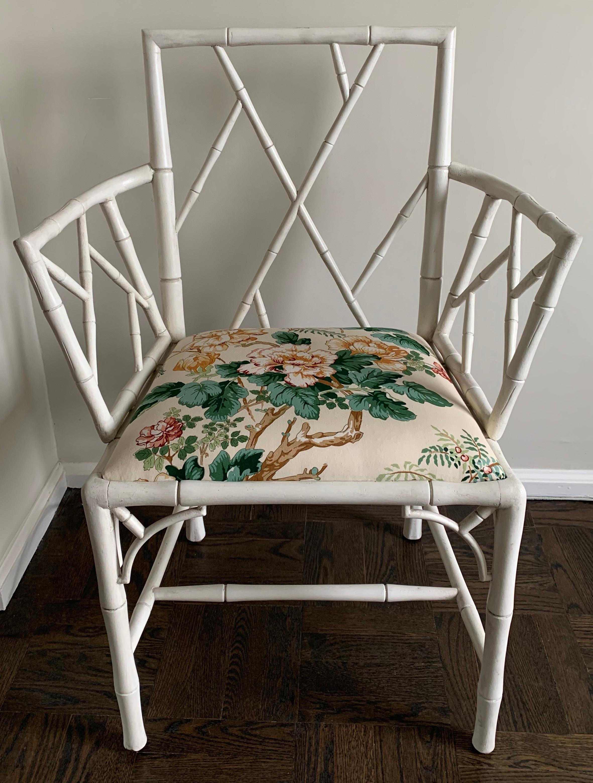 Pair of English 1940s white faux bamboo armchairs. Newly repainted in antique white finish. Newly upholstered in Lee Jofa Chinese Peony chintz fabric. Measures: Seat is 21