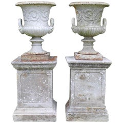 Pair of English 19th Century Cast Iron Garden Urns on Stone Plinths