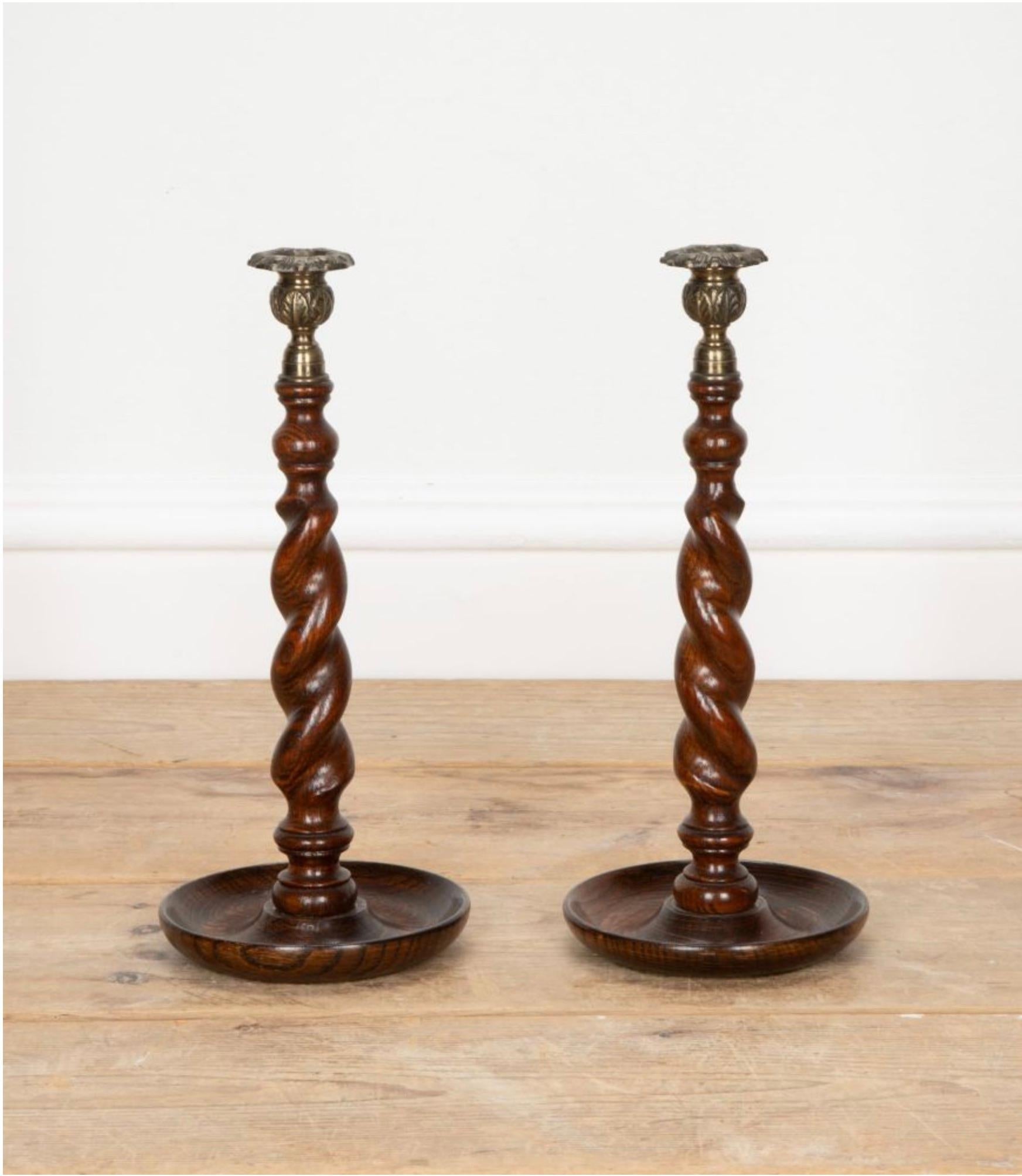 Pair of English oak barley twist candle sticks with brass sconces.

In good original condition, Circa 1900.