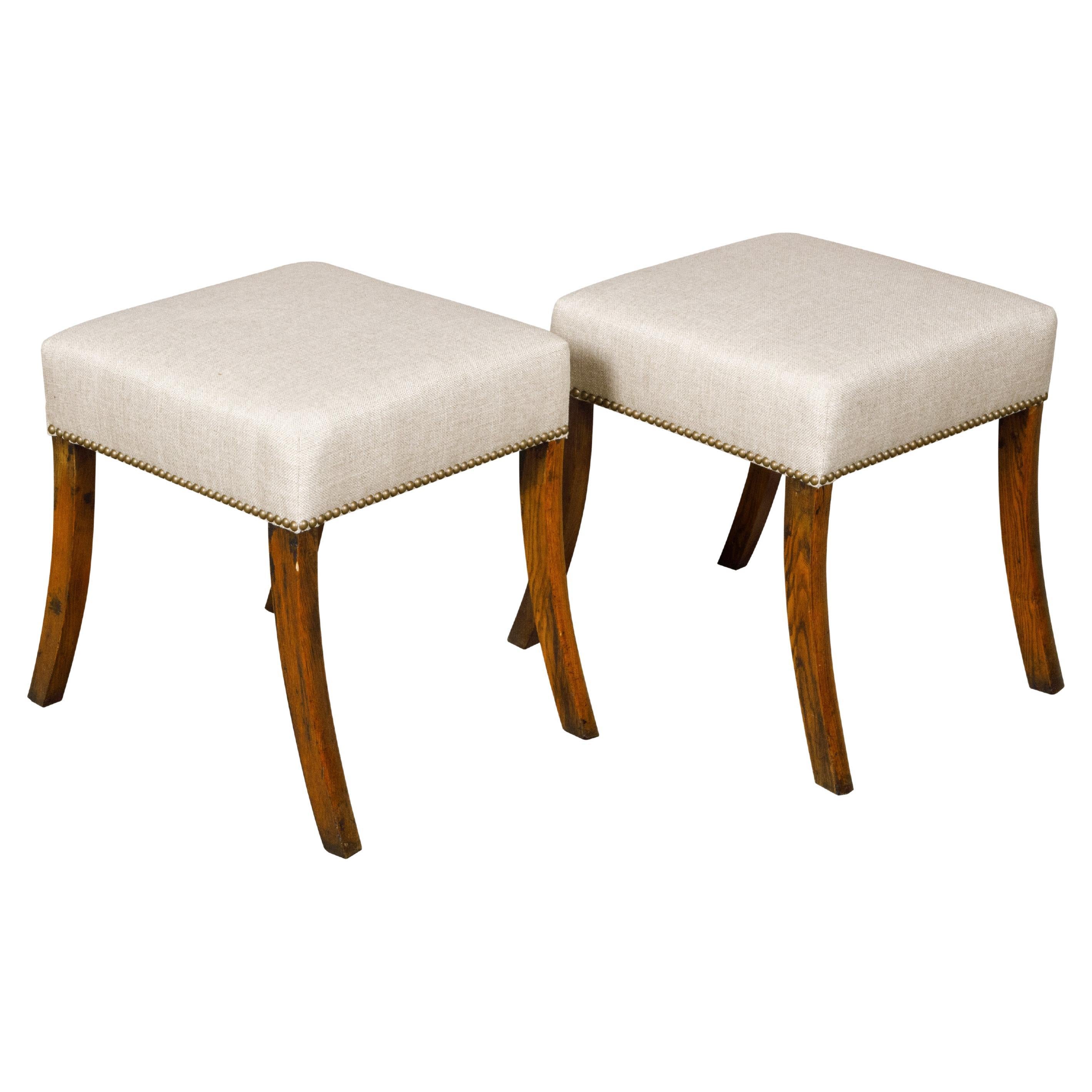 Pair of English 19th Century Oak Stools with Saber Legs and Custom Upholstery