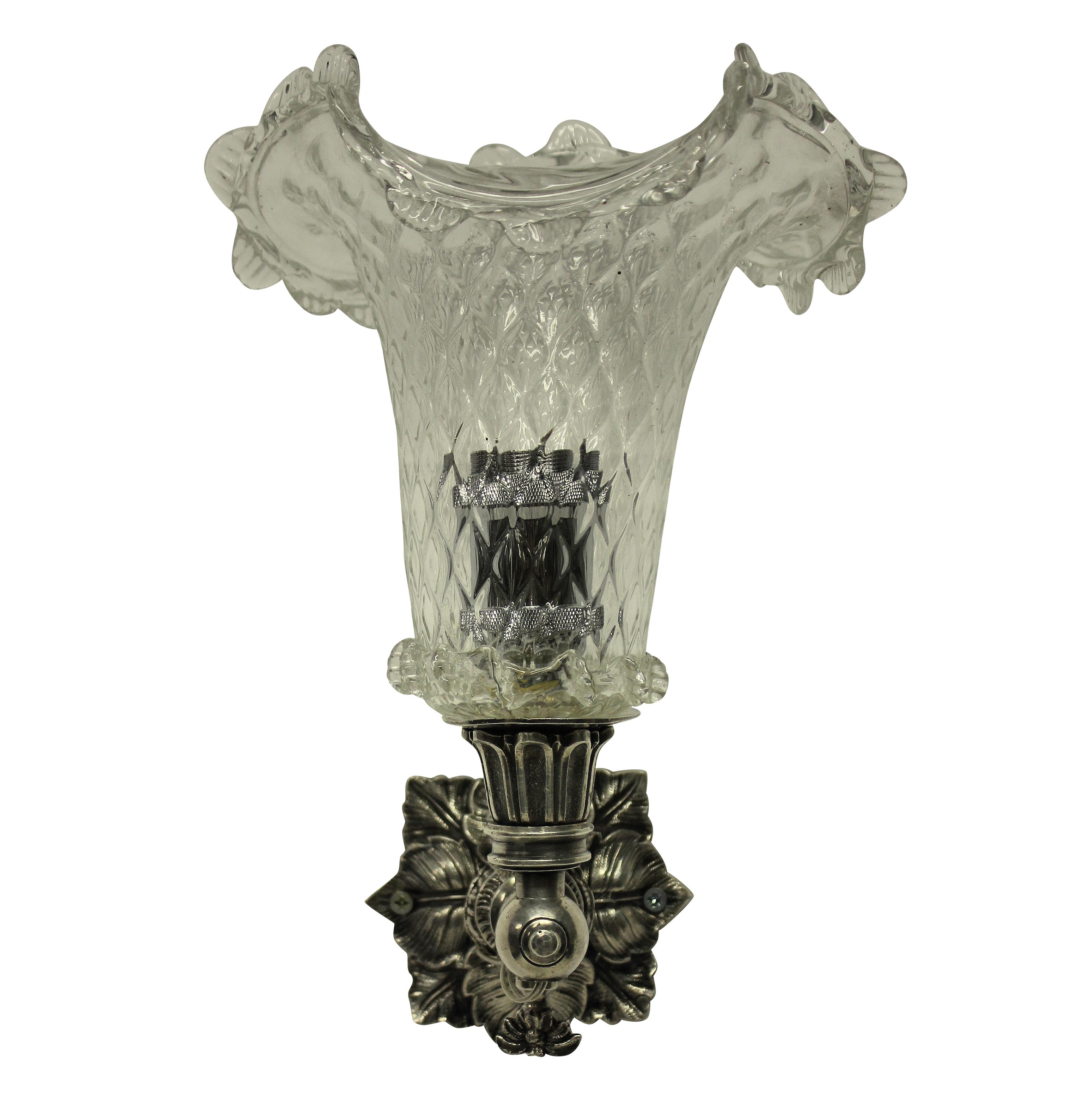 A pair of English 19th century single wall sconces, formerly for gas. With silver plated bronze fixtures and hand blown basket shaped glass shades.