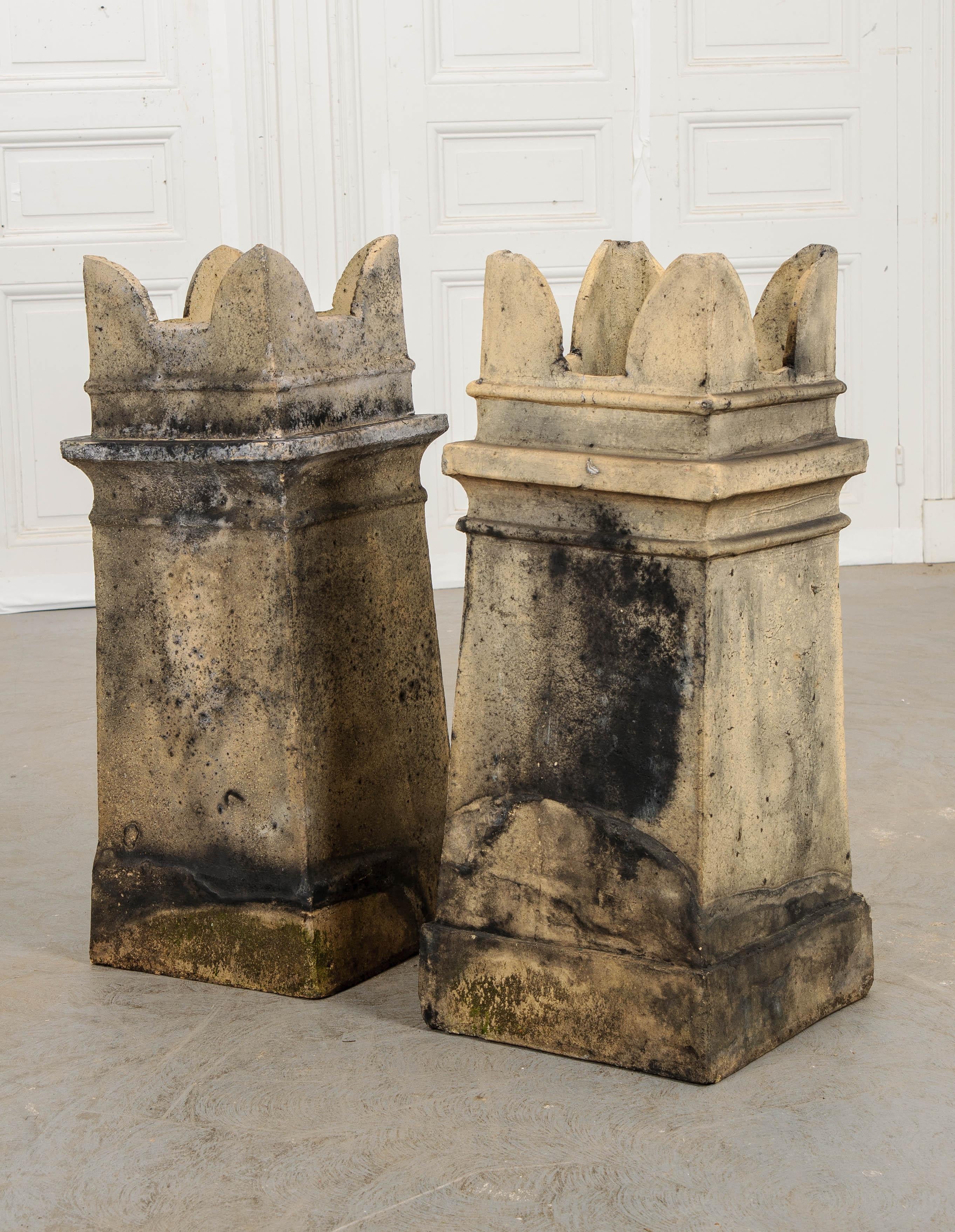 A stunning pair of English terracotta chimney pots, dating to the Victorian era. These antique architectural elements serve as both decorative and functional additions to traditional chimney flues. During the 1800s, coal was used more and more to