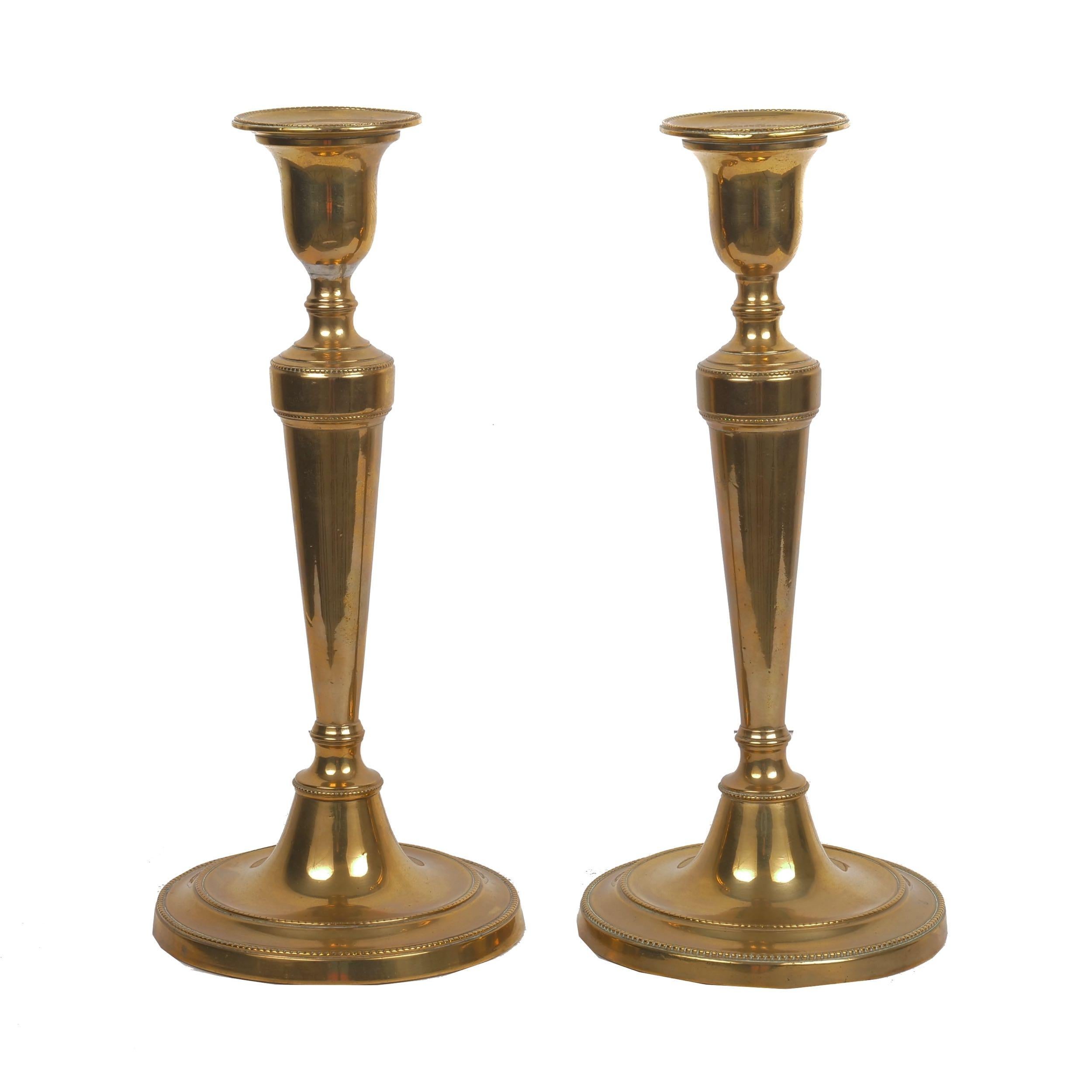 Pair of George III turned brass swollen-baluster candlesticks
England, circa early 19th century
Item # C104019 

A most attractive pair of Georgian turned brass candlesticks with swollen-baluster stems over turned bases and raised-relief