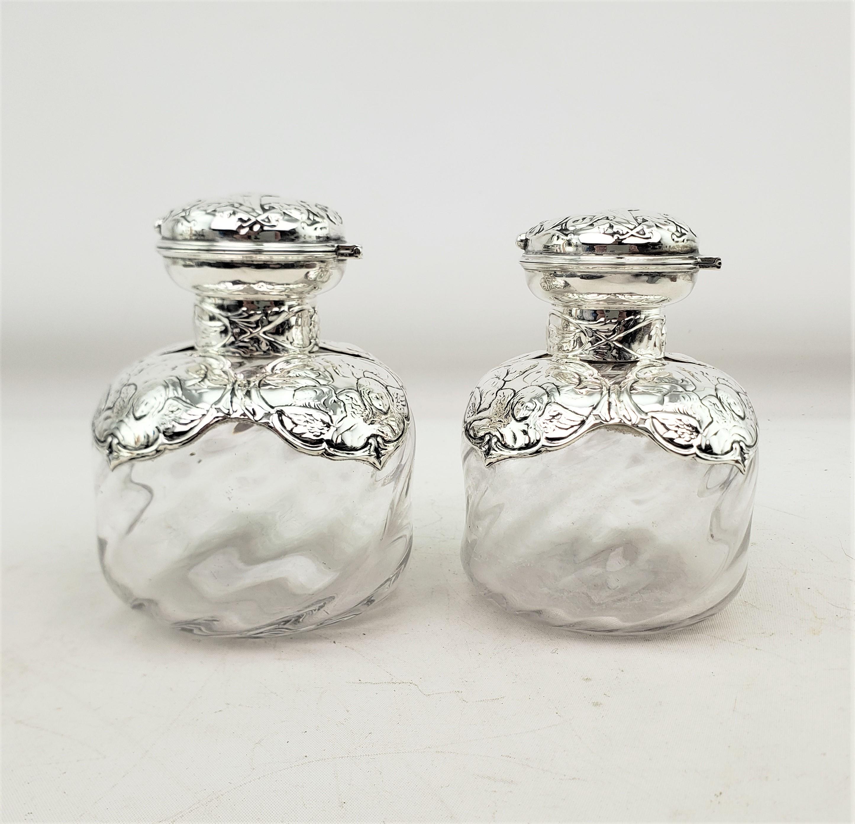 Hand-Crafted Pair of English Antique Perfume Bottles with Sterling Silver Repousse Angels For Sale