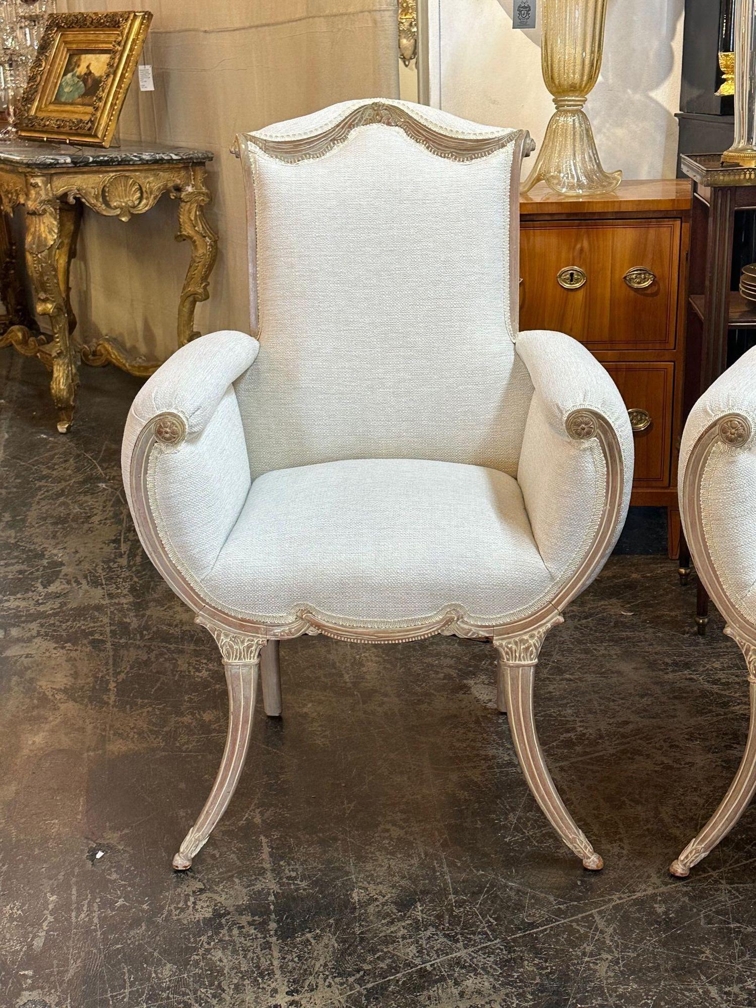 Pair of early 20th century English Adams style carved and white washed arm chairs, circa 1920. Perfect for today's transitional designs!