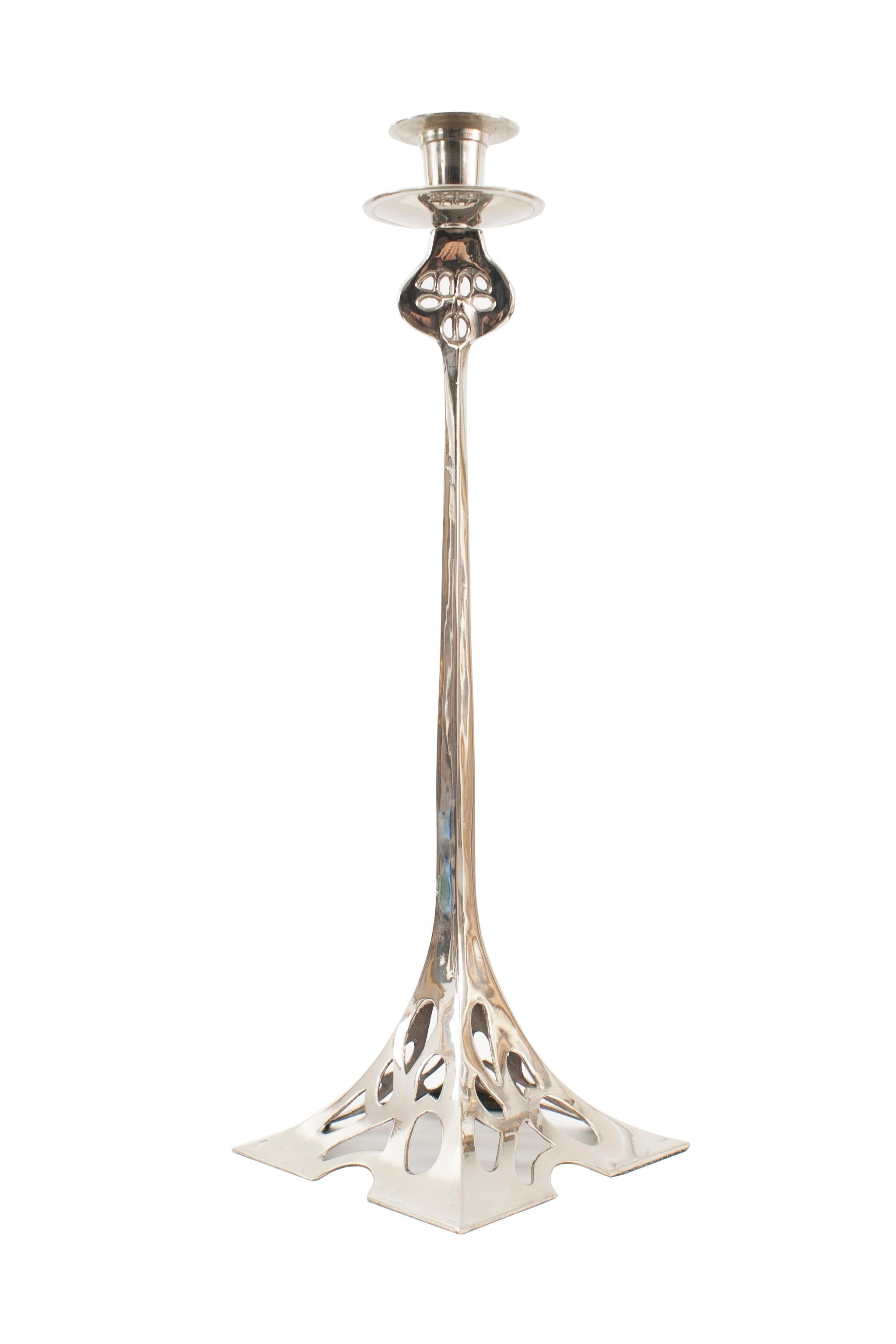 Pair of English Arts & Crafts silver plated pewter candlesticks with a square tapered filigree base and an filigree open top supporting a candleholder.
 