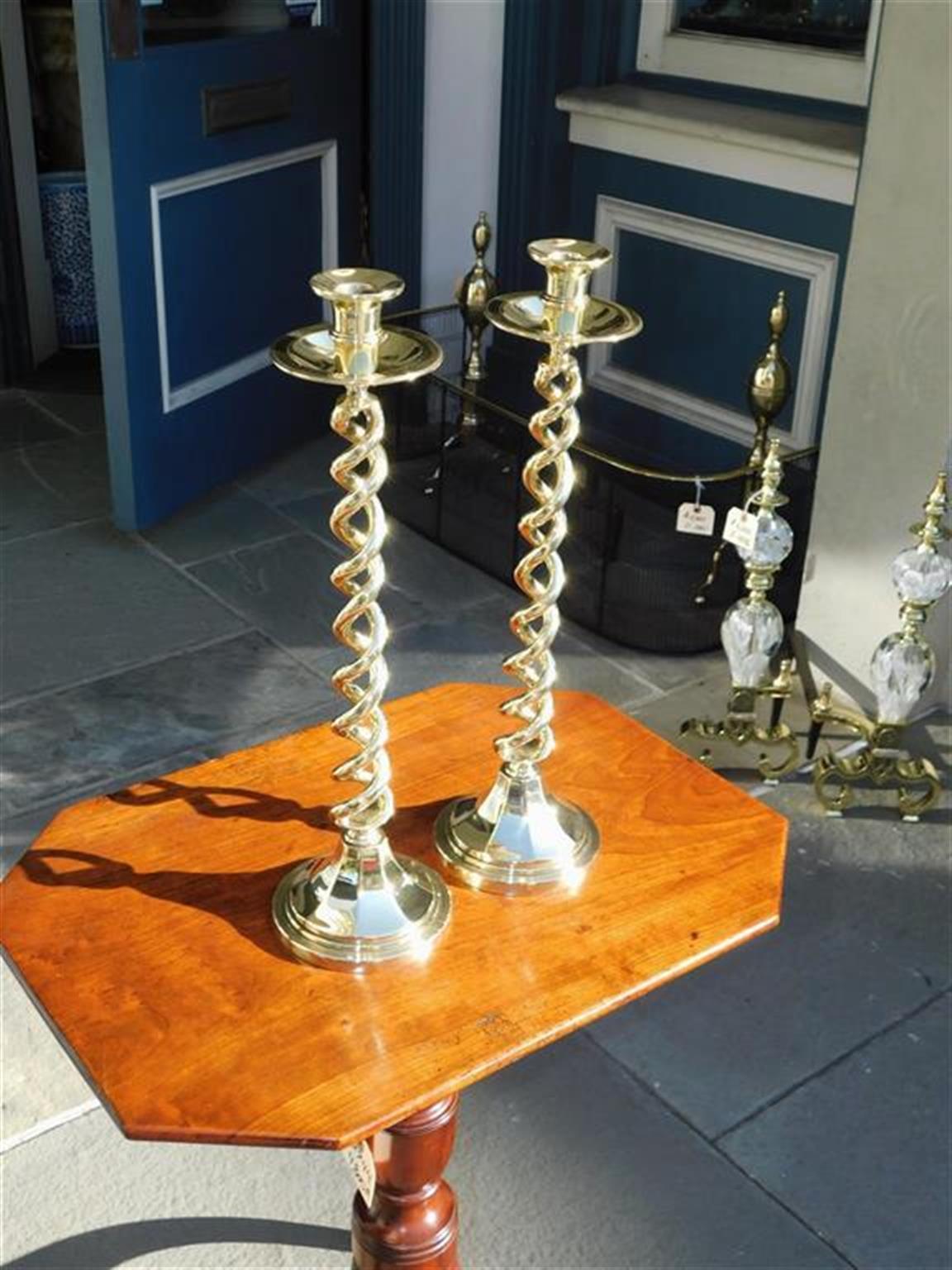 Pair of English barley twist single candlesticks with flanking bobeches and circular faceted reeded bases, Mid 19th century.