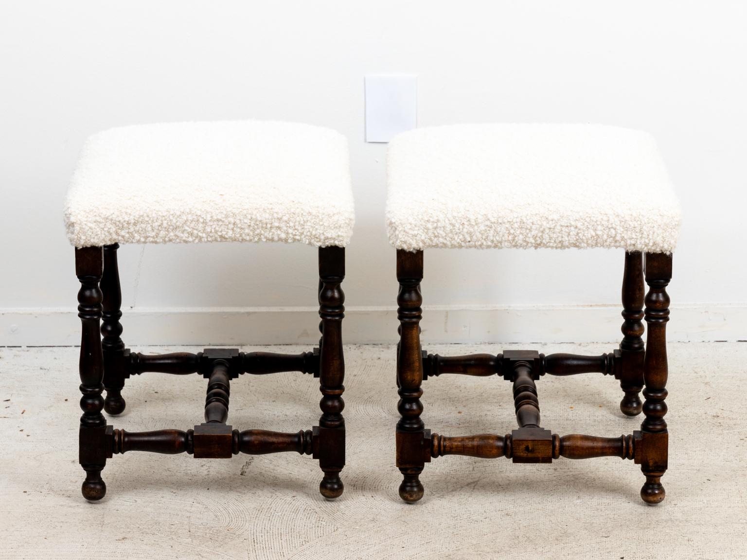 Circa 1890s pair of English style walnut benches freshly upholstered on turned legs. Made in England. Please note of wear consistent with age.