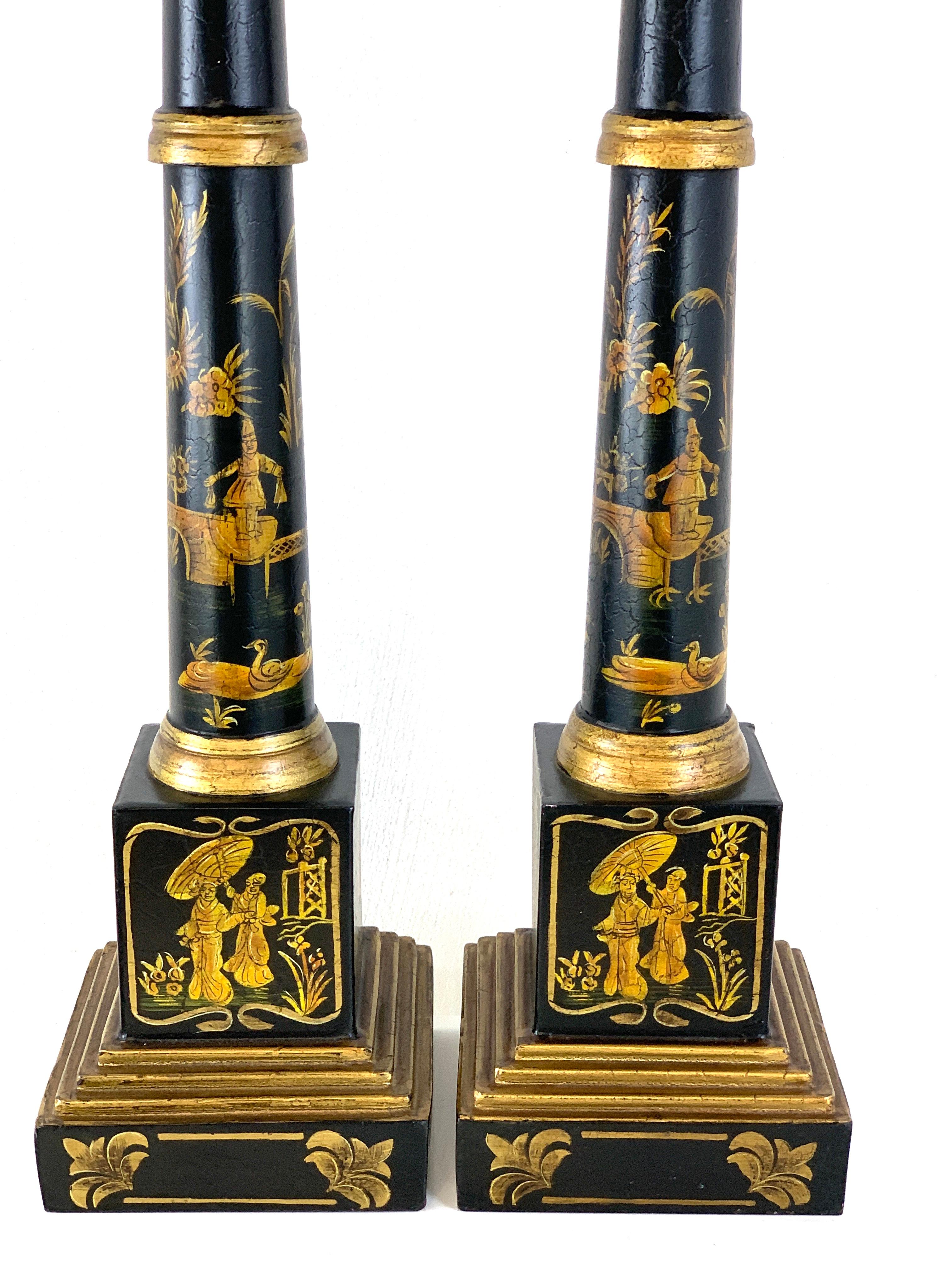 Pair of English black tole gilt chinoiserie column lamps, beautifully decorated on all sides. New wiring
Measures: 6