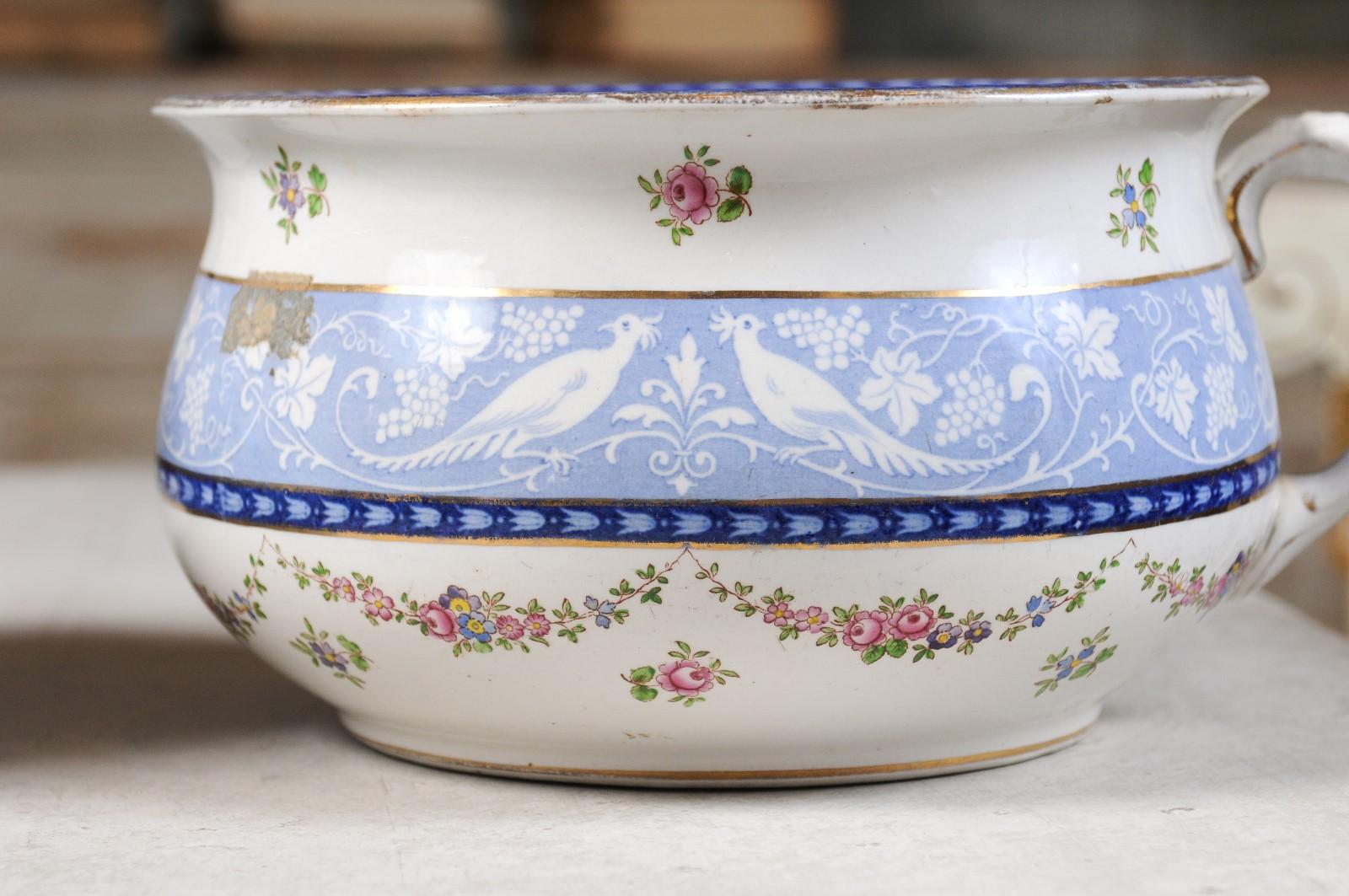 A pair of booths blue and white China bowls produced for Harrods in London, with birds and garlands of flowers, from the early 20th century. Created in England for Harrods by Booths who became known for their high quality earthenware (which they