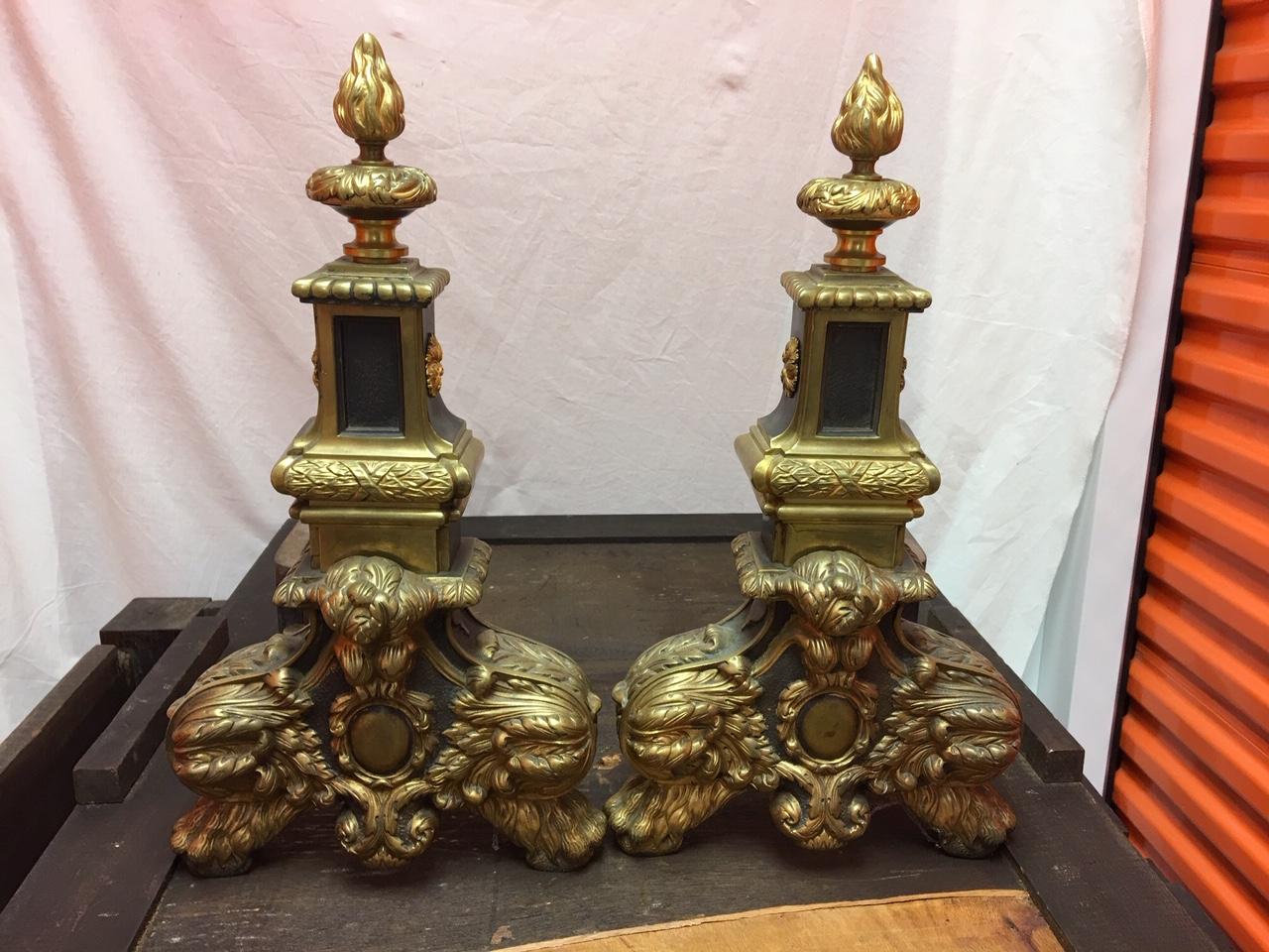 Pair of English brass black andirons with flame finials, 19th century.