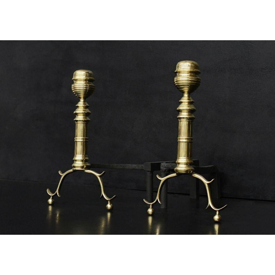 A pair of brass firedogs. The decorative feet surmounted by turned columns and finials above. English, circa 1900.

Additional information:
Height: 415 mm / 16 ⅜