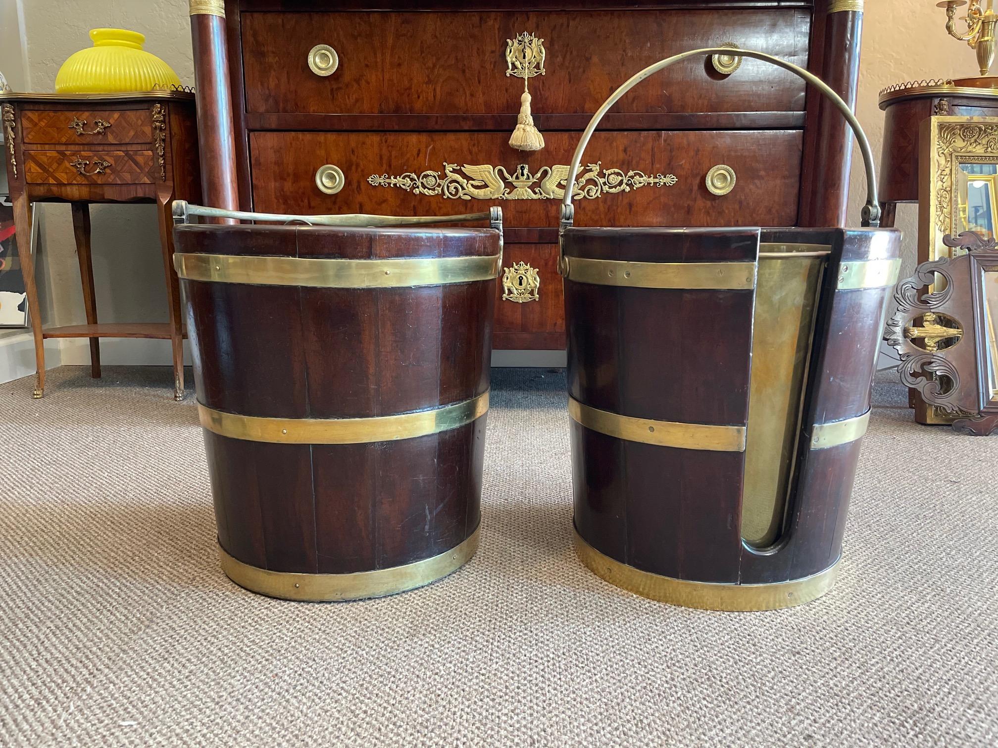 A pair (not identical match but from the same maker) peat or plate buckets. Mahogany and brass, outstanding construction, heavy and well made, with beautiful brass details. Made in England, circa 1770-1790.