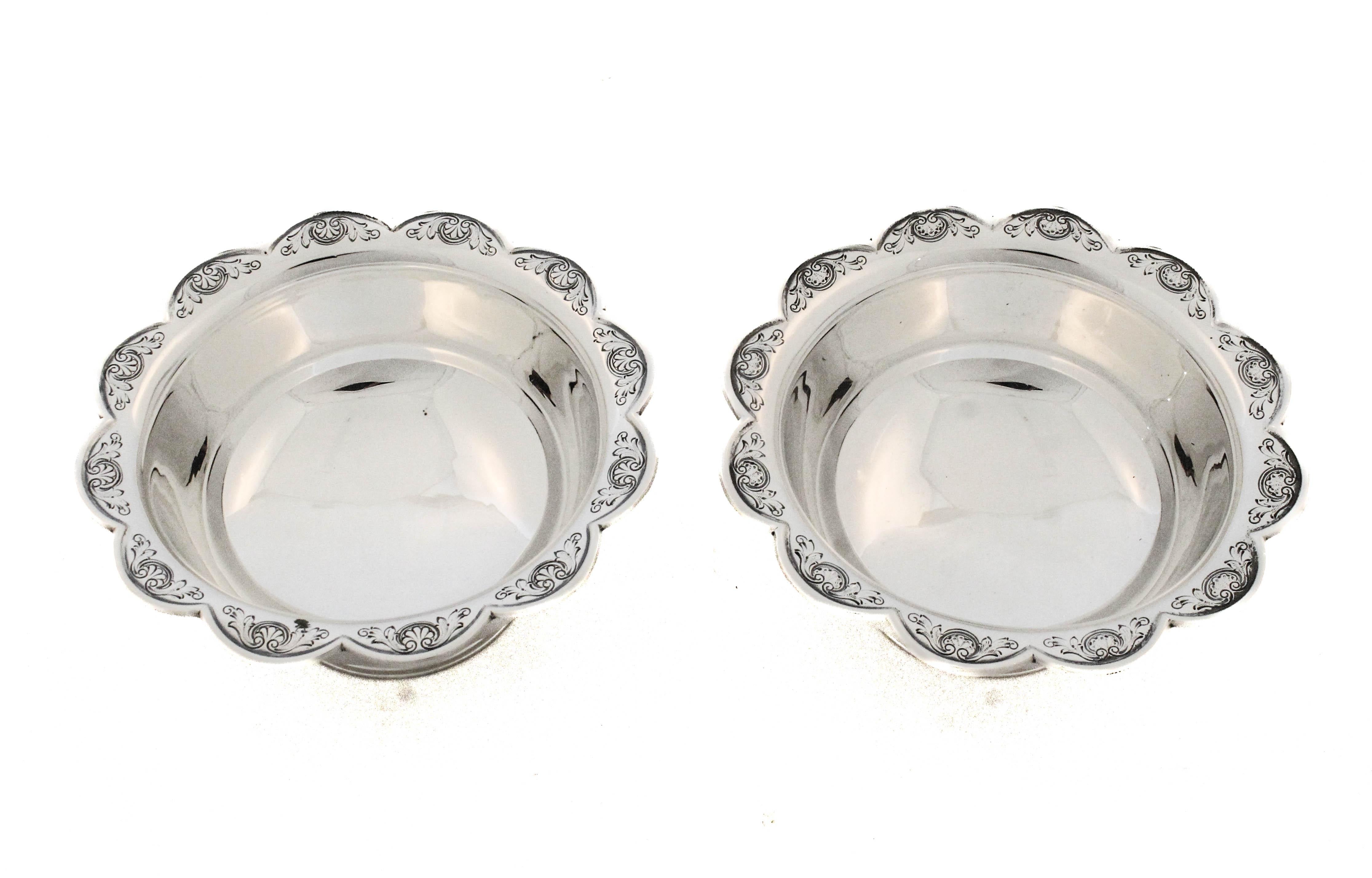 An elegant pair of sterling silver candy dishes crafted by Adie Brothers of Birmingham, England, renowned silversmiths active in the early 20th century. Each dish stands gracefully on a raised pedestal base, offering a refined sense of balance and