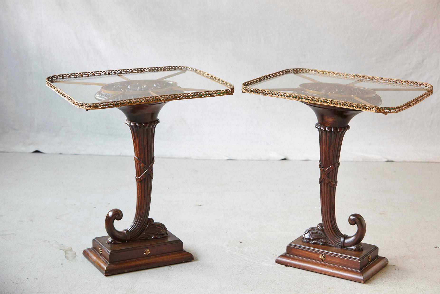 Striking pair of English early 20th century elaborately hand-carved walnut cornucopia side tables with rectangular glass tops with rounded corners based on brass supports and pierced brass galleries.
Each cornucopia is mounted on a square base