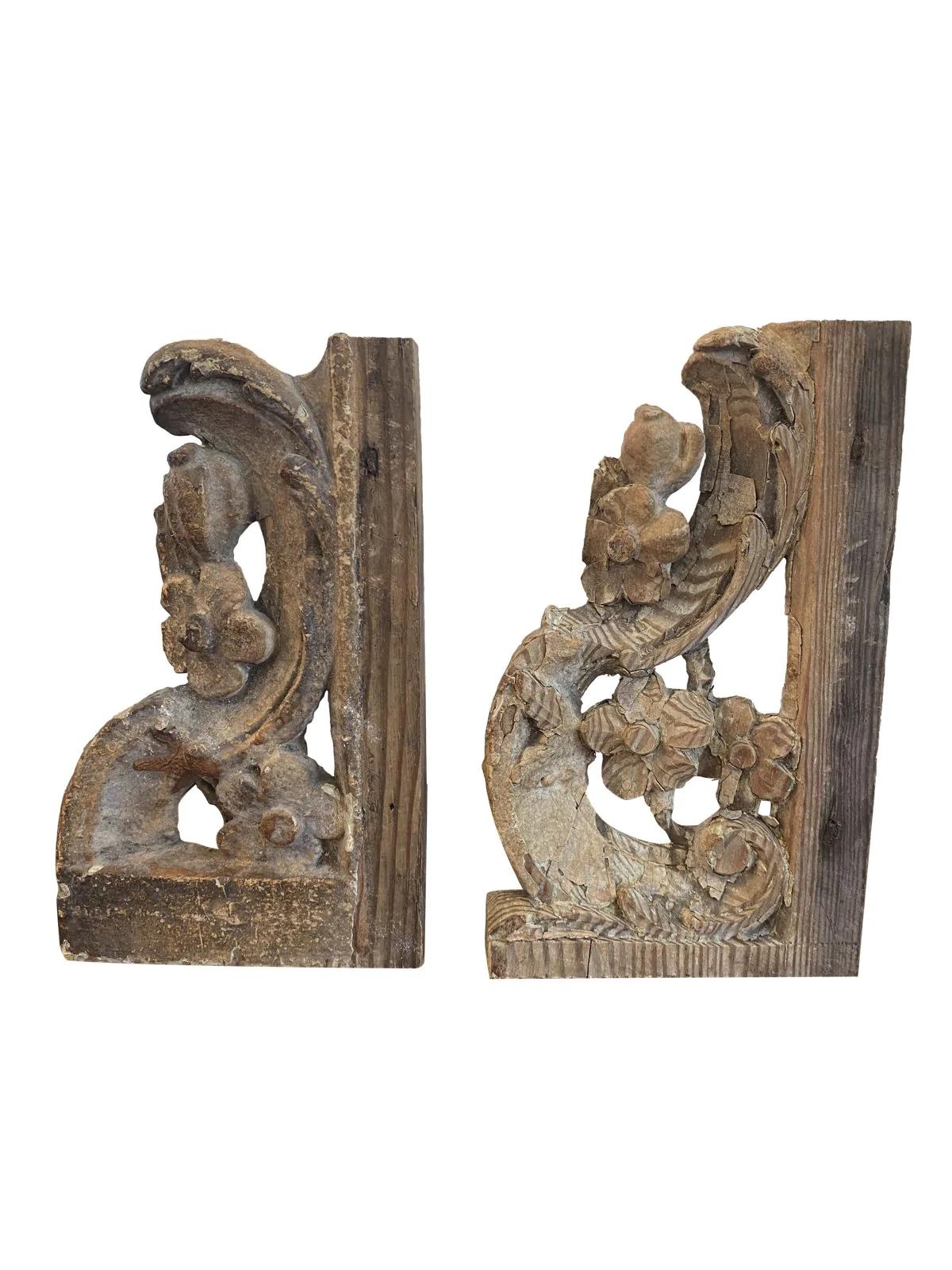 Pair of English carved stair brackets, c. 1760, both with a foliate S-curve adorned with flowers.
