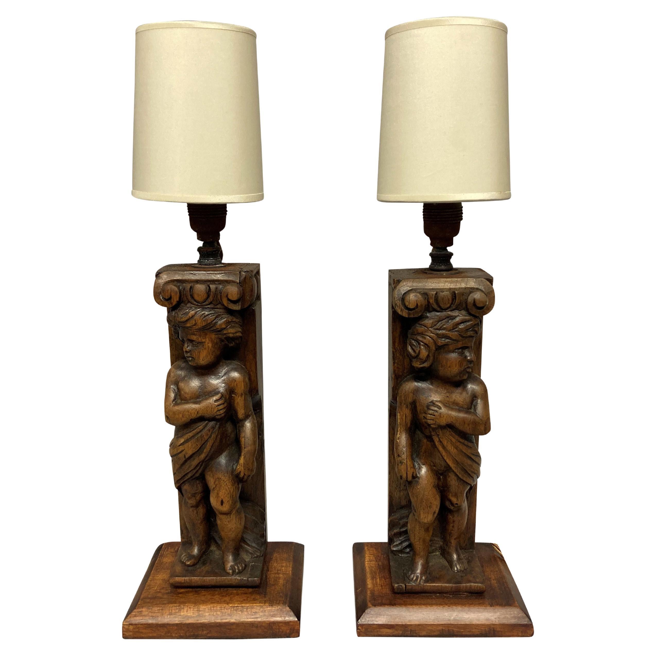 Pair of English Carved Walnut Cherub Lamps For Sale
