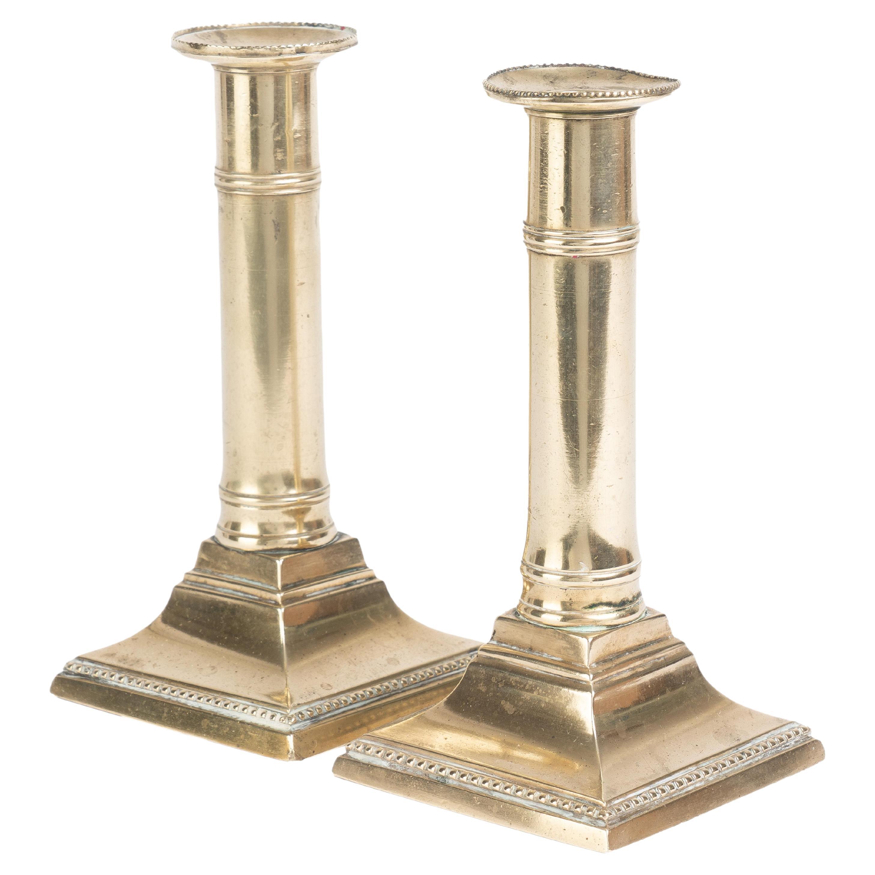 Pair of English Cast Brass Columnar Candle Sticks on a Square Base, 1810 For Sale