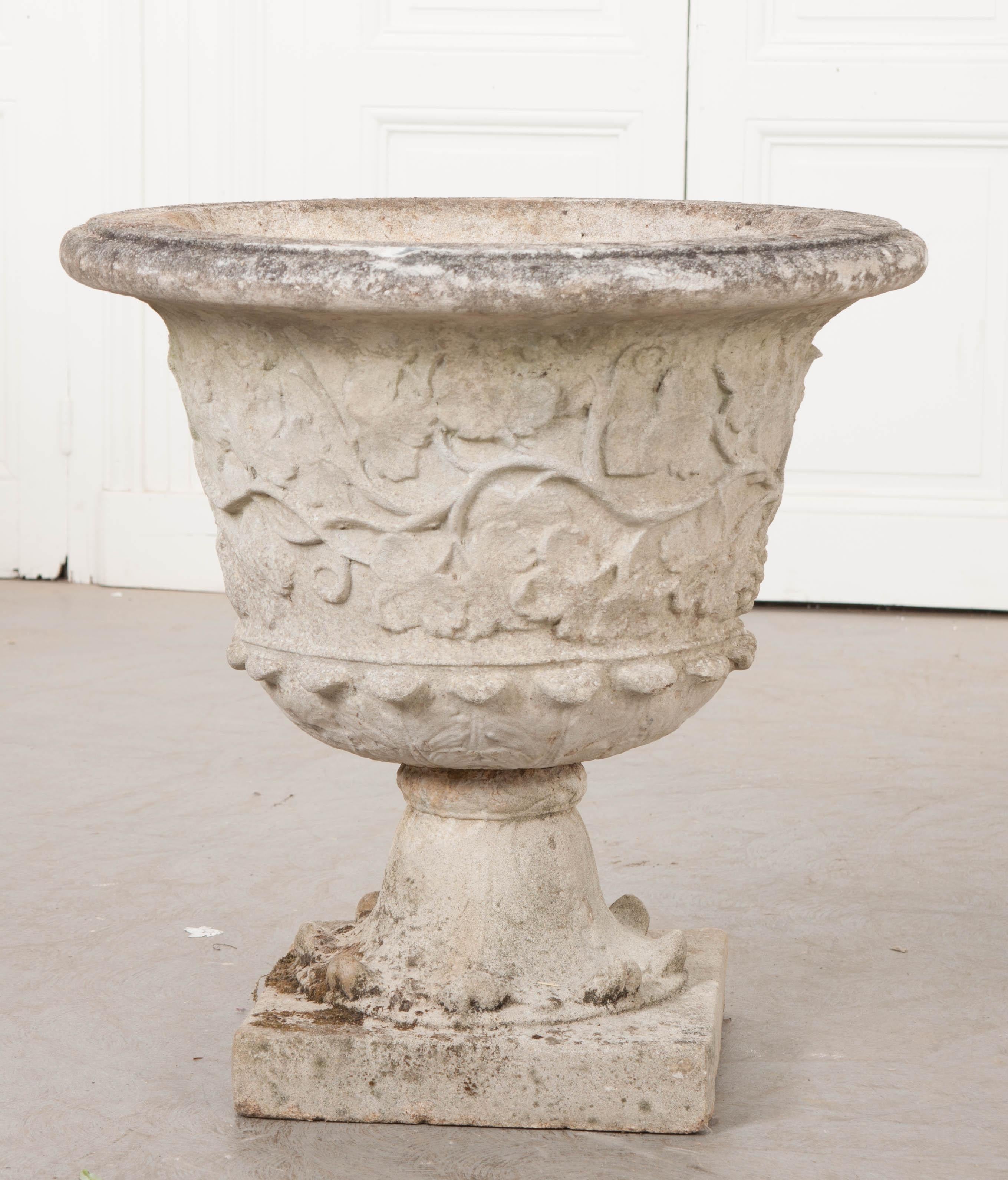 This wonderful pair of cast-stone garden urns, circa 1870s, was found in England and feature a lovely scrolling vine motif. The urns and bases are separate pieces and each is drilled for proper water drainage. Measures: Urns 15-1/2? H x 18-1/2?