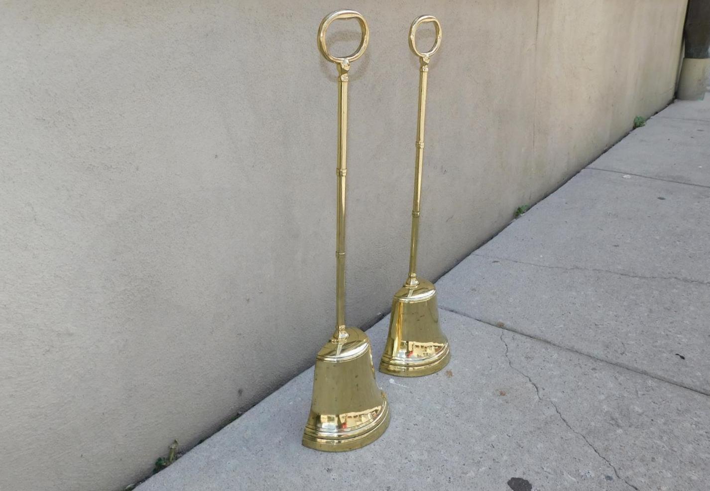 Pair of Monumental English Chippendale brass bell shaped doorstops with bulbous banded columns, oval handles, and resting on the original lead lined interior bases, Late 18th Century