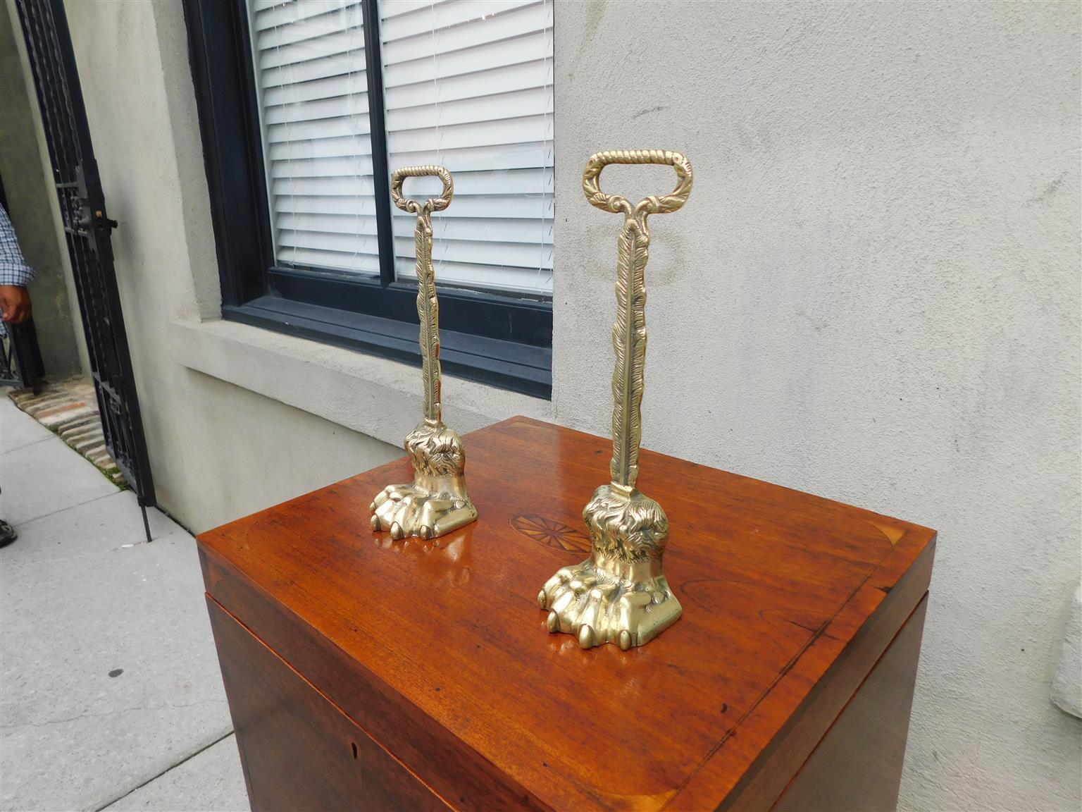 Cast Pair of English Chippendale Brass Lion Paw Doorstops with Oval Handles, C. 1780 For Sale