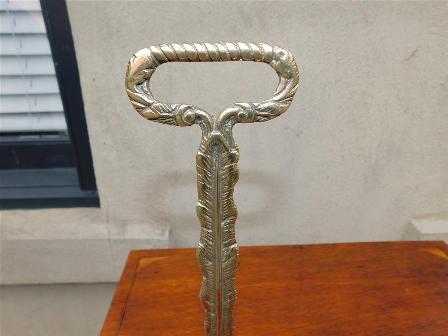 Late 18th Century Pair of English Chippendale Brass Lion Paw Doorstops with Oval Handles, C. 1780 For Sale