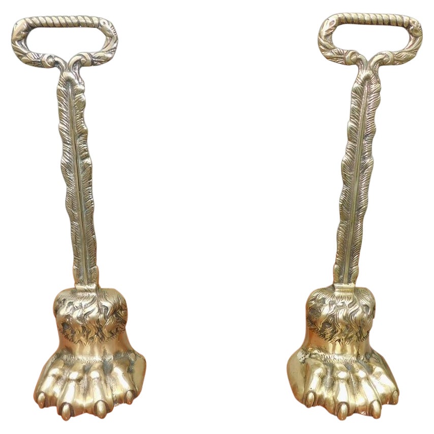 Pair of English Chippendale Brass Lion Paw Doorstops with Oval Handles, C. 1780 For Sale