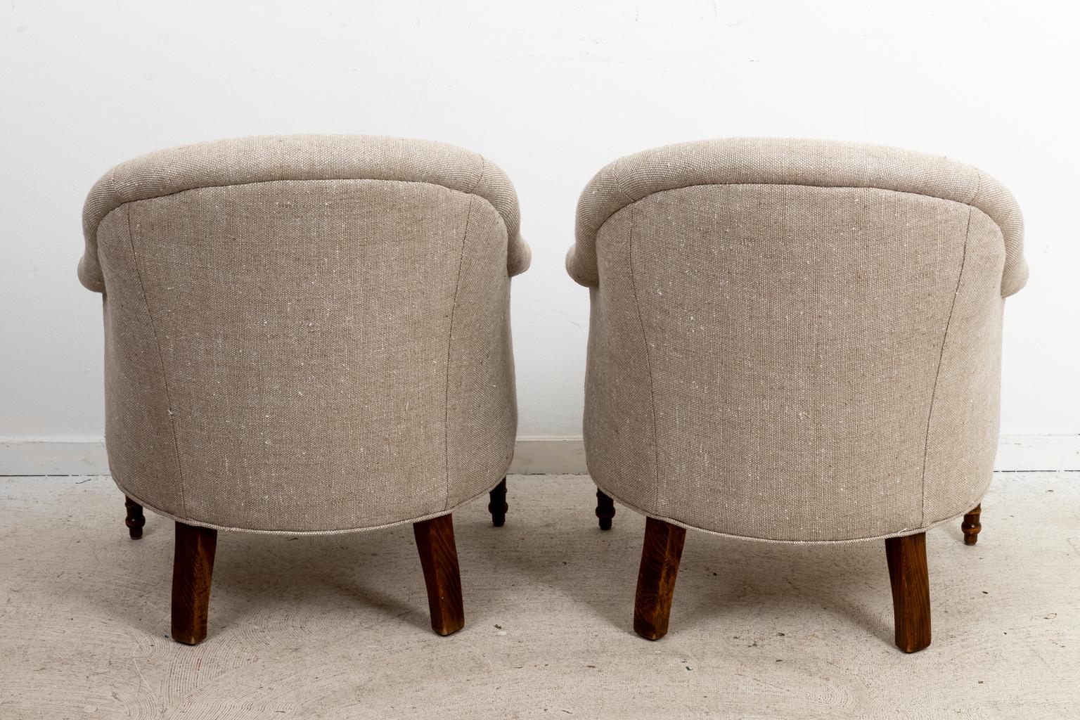 Pair of English club chairs, freshly upholstered in Linen. Made in England. Please note of wear consistent with age.