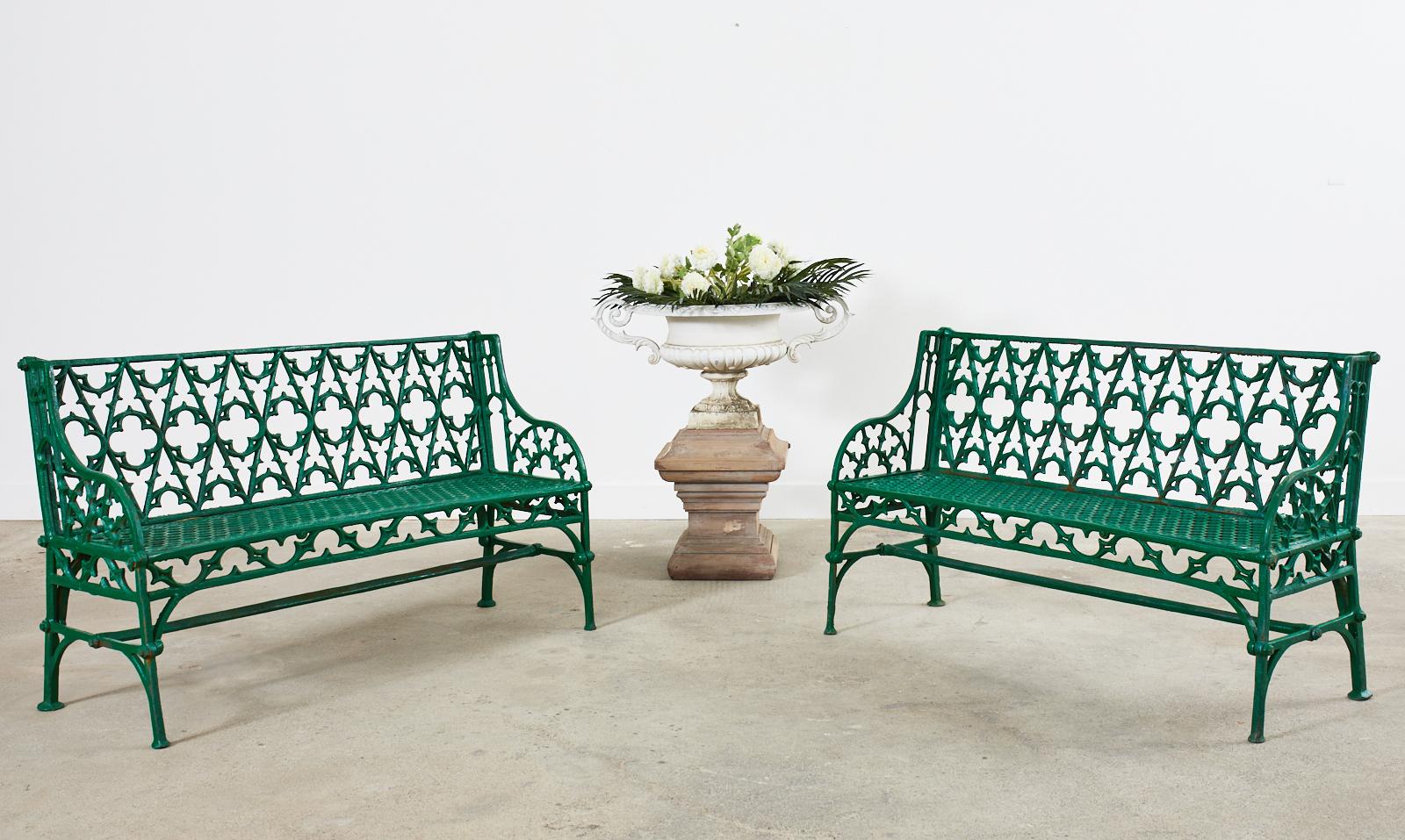 Spectacular pair of kelly green lacquered English Coalbrookdale foundry attributed cast iron garden benches. Made in the dramatic gothic revival taste featuring a gothic tracery backrest centered by quatrefoil form designs. The gracefully curved