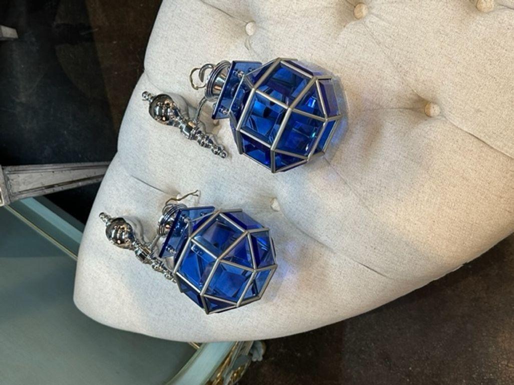 Rare pair of vintage English cobalt glass and silver wall lanterns. Circa 1940. The sconces have been professionally rewired and ready to hang.