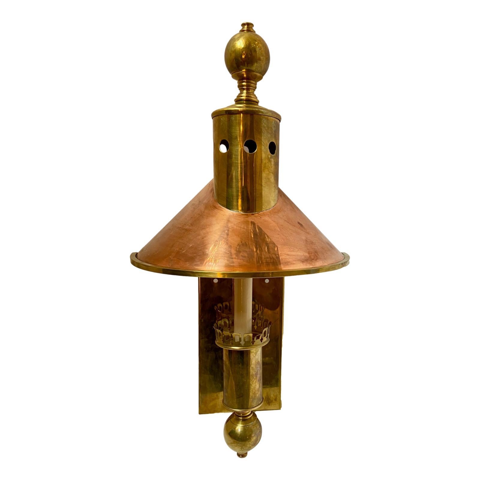 A pair of circa 1950's English single-light copper sconces with brass backplate.

Measurements:
Height: 21